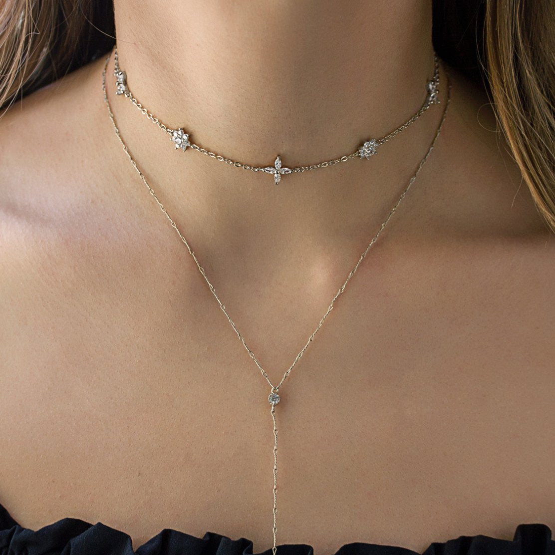 Sterling silver crystal flower choker layered over a longer chain, shown on a model