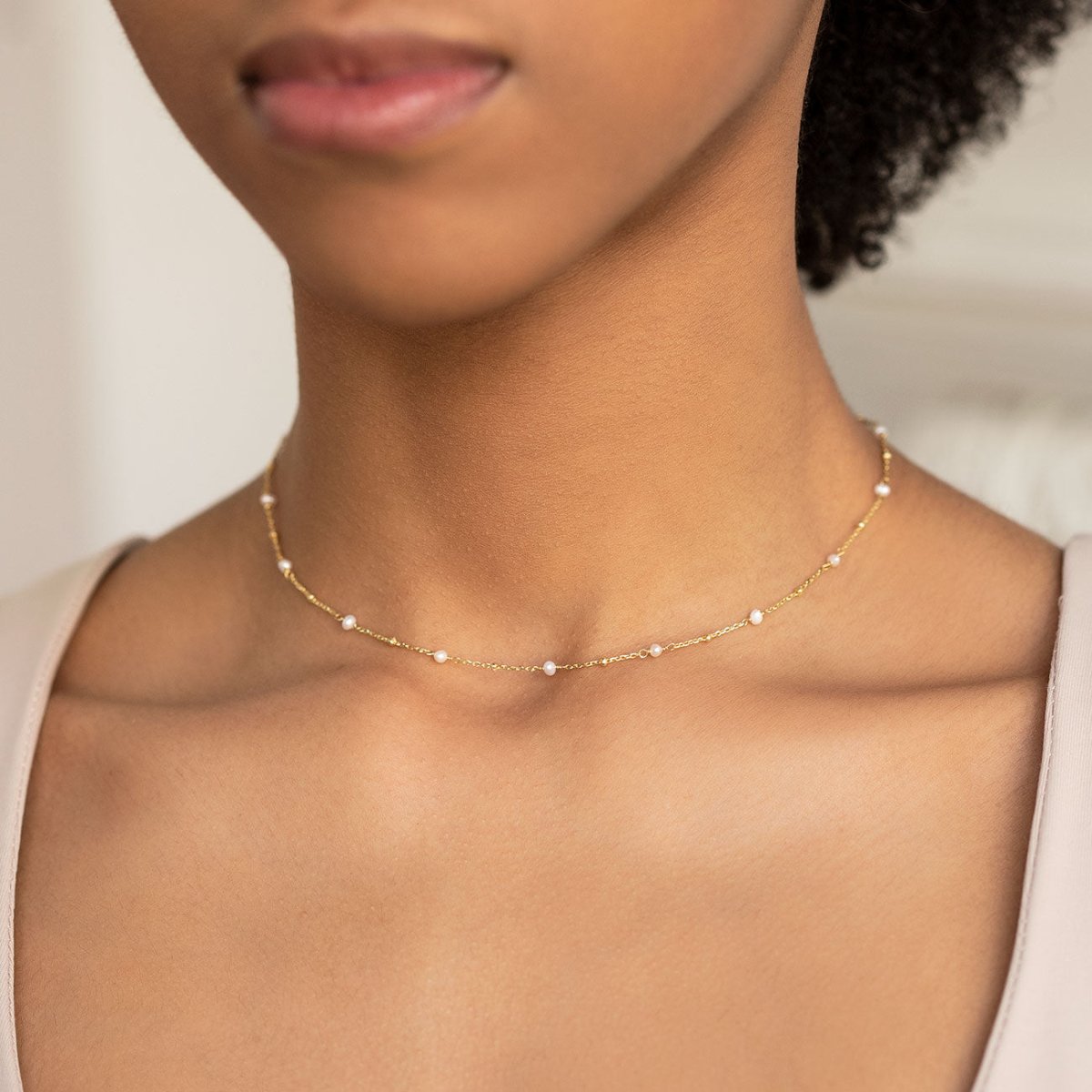 Gold vermeil pearl choker necklace shown on a model's neckline