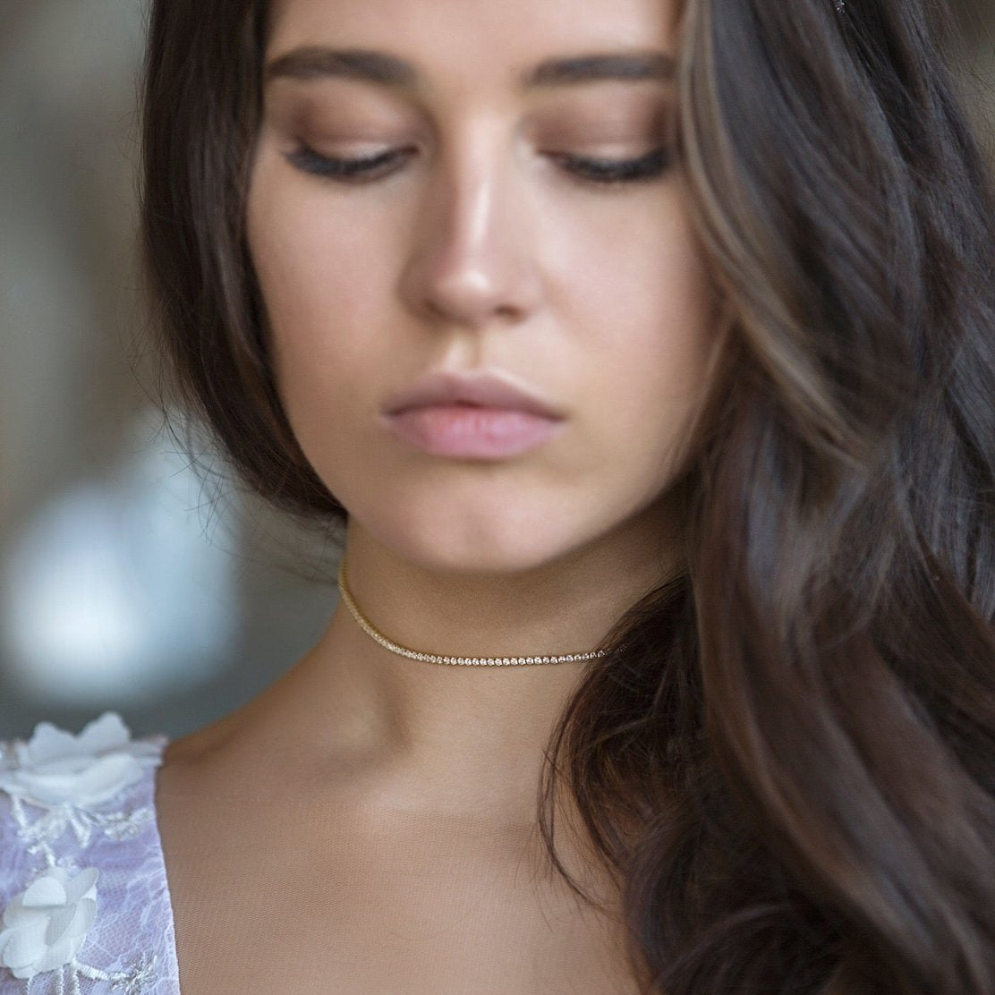 Sterling silver crystal choker with round clear stones, shown close at a model's neckline