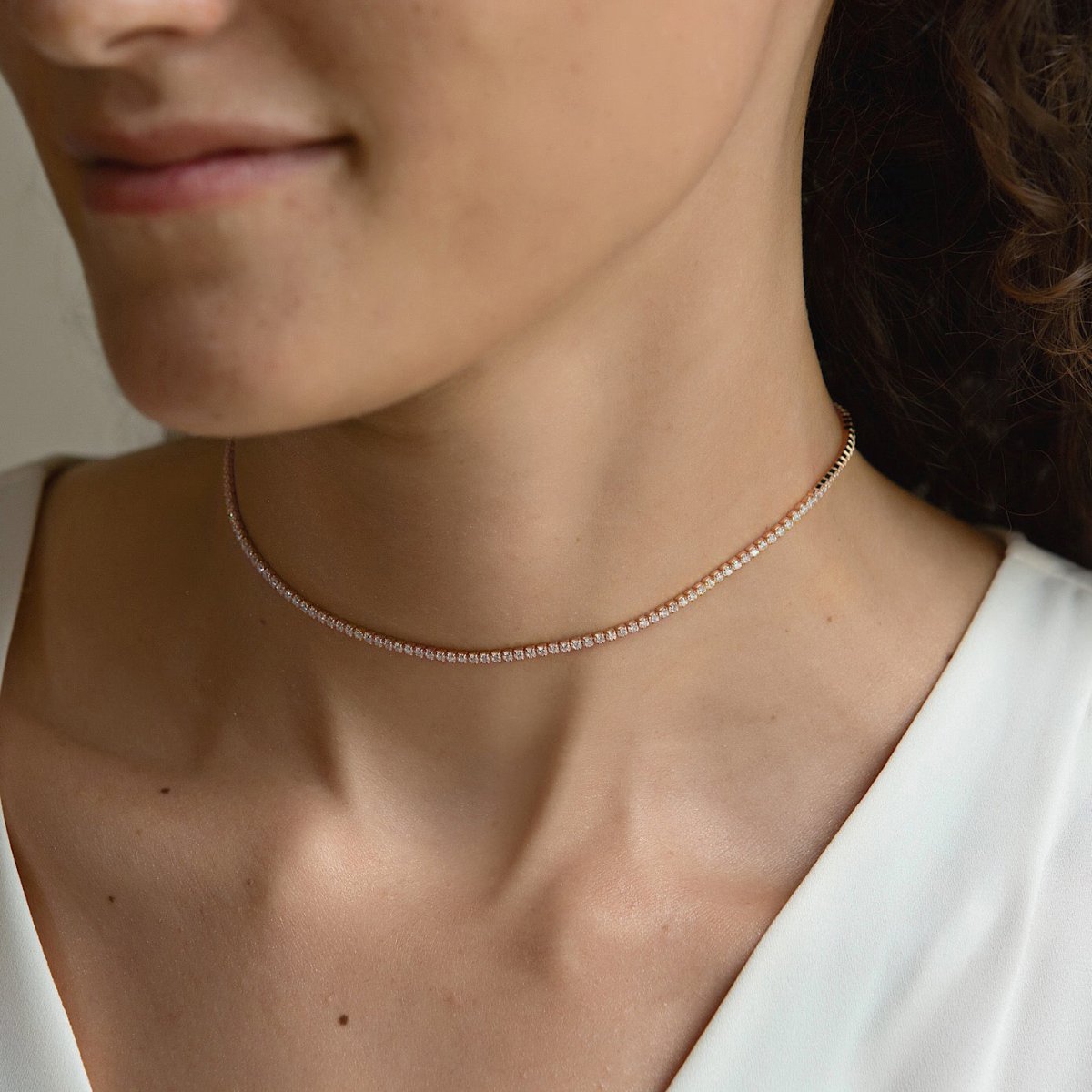 Rose gold vermeil crystal choker with round clear stones, shown on a model's neckline