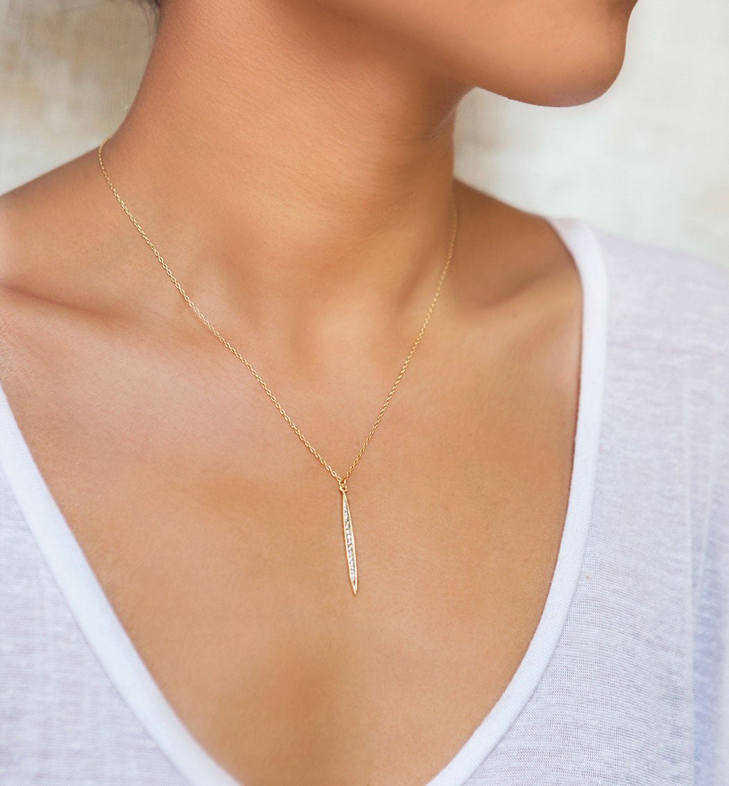 Gold vermeil pavé white zirconia spike pendant shown on a model's neckline