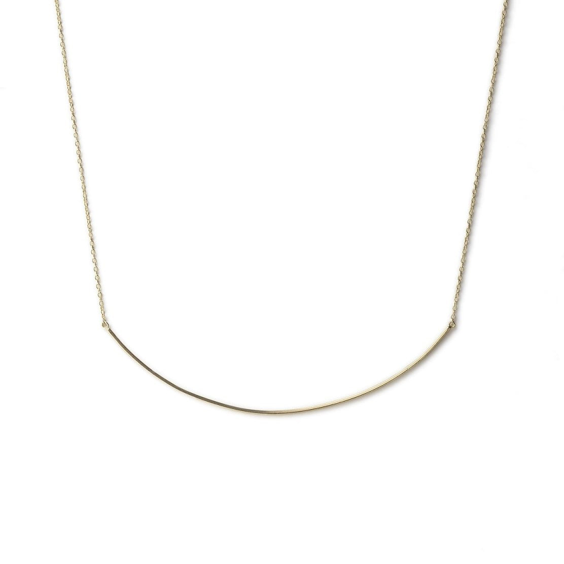 Gold vermeil curved bar necklace on a fine chain, laid on a white background