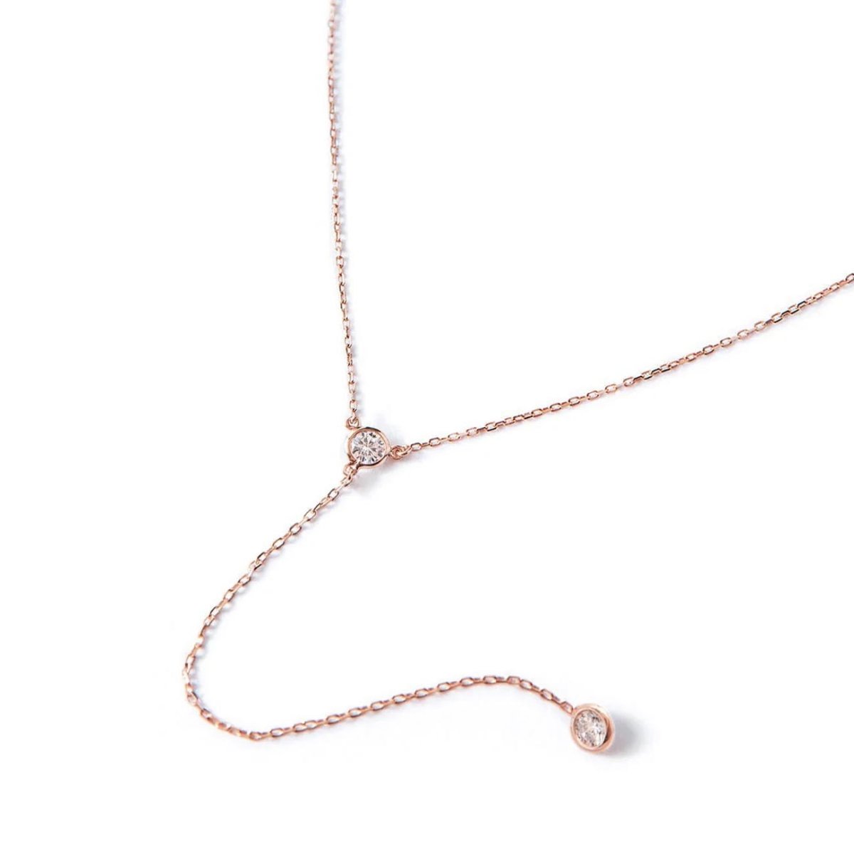 Rose gold vermeil zirconia lariat necklace with a bezel-set drop, on a white background