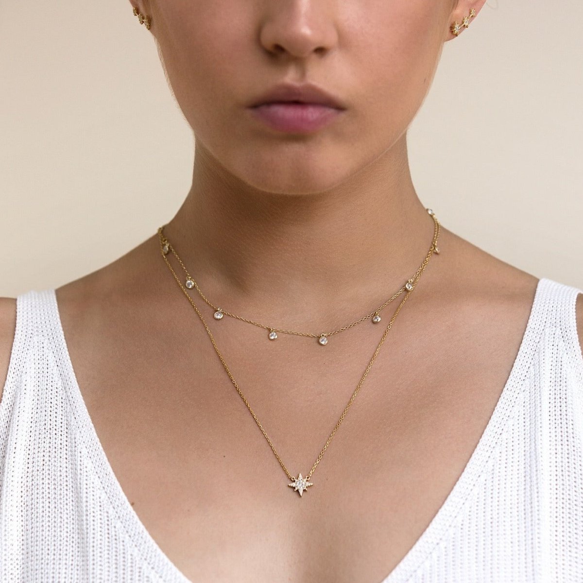 Gold vermeil dangling clear stone choker, shown layered on a model's neckline