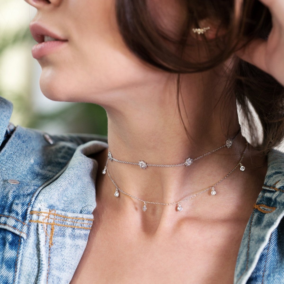 Sterling silver white zirconia flower choker layered with a drop necklace, on a model