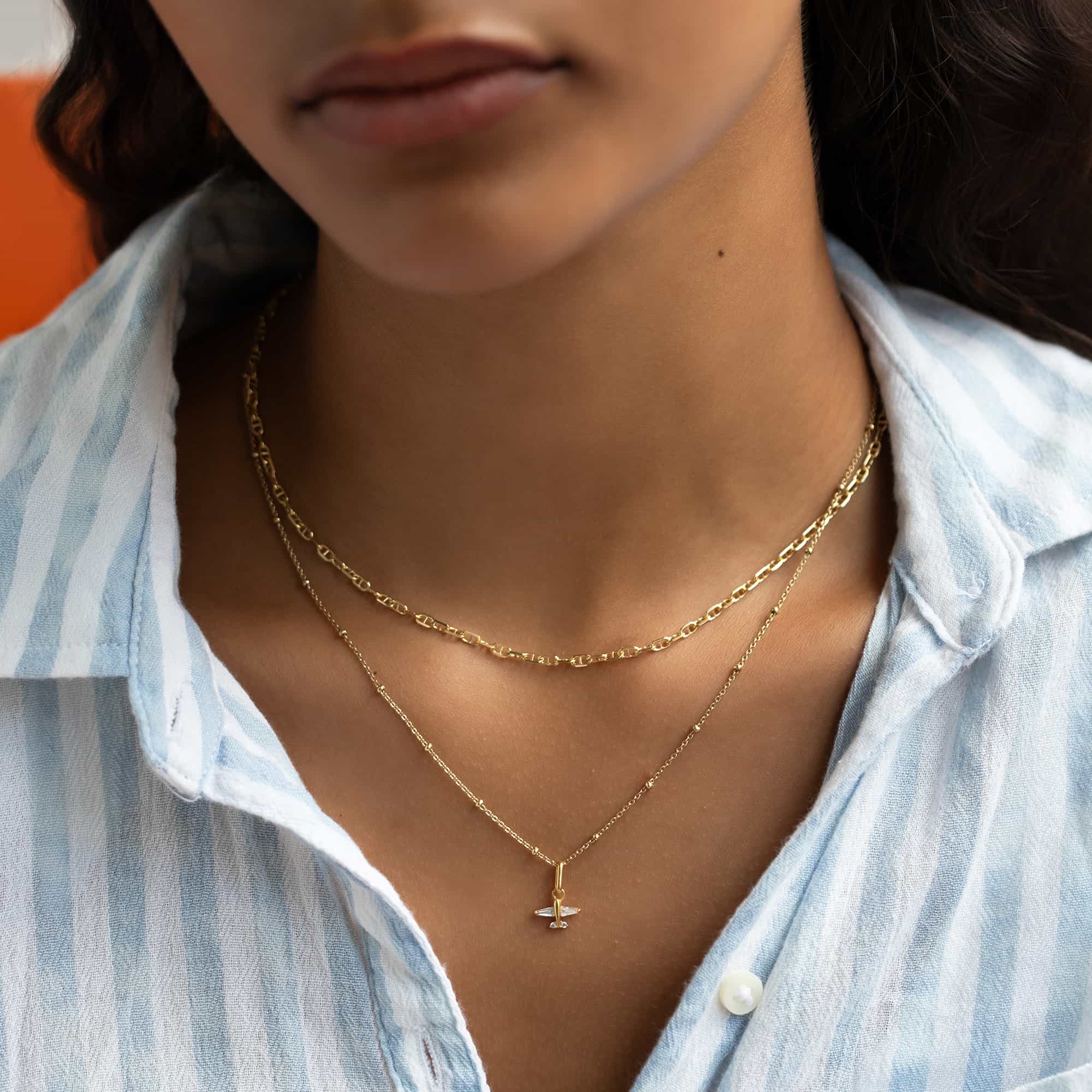 Gold vermeil beaded chain choker layered with a longer chain on a model's neckline