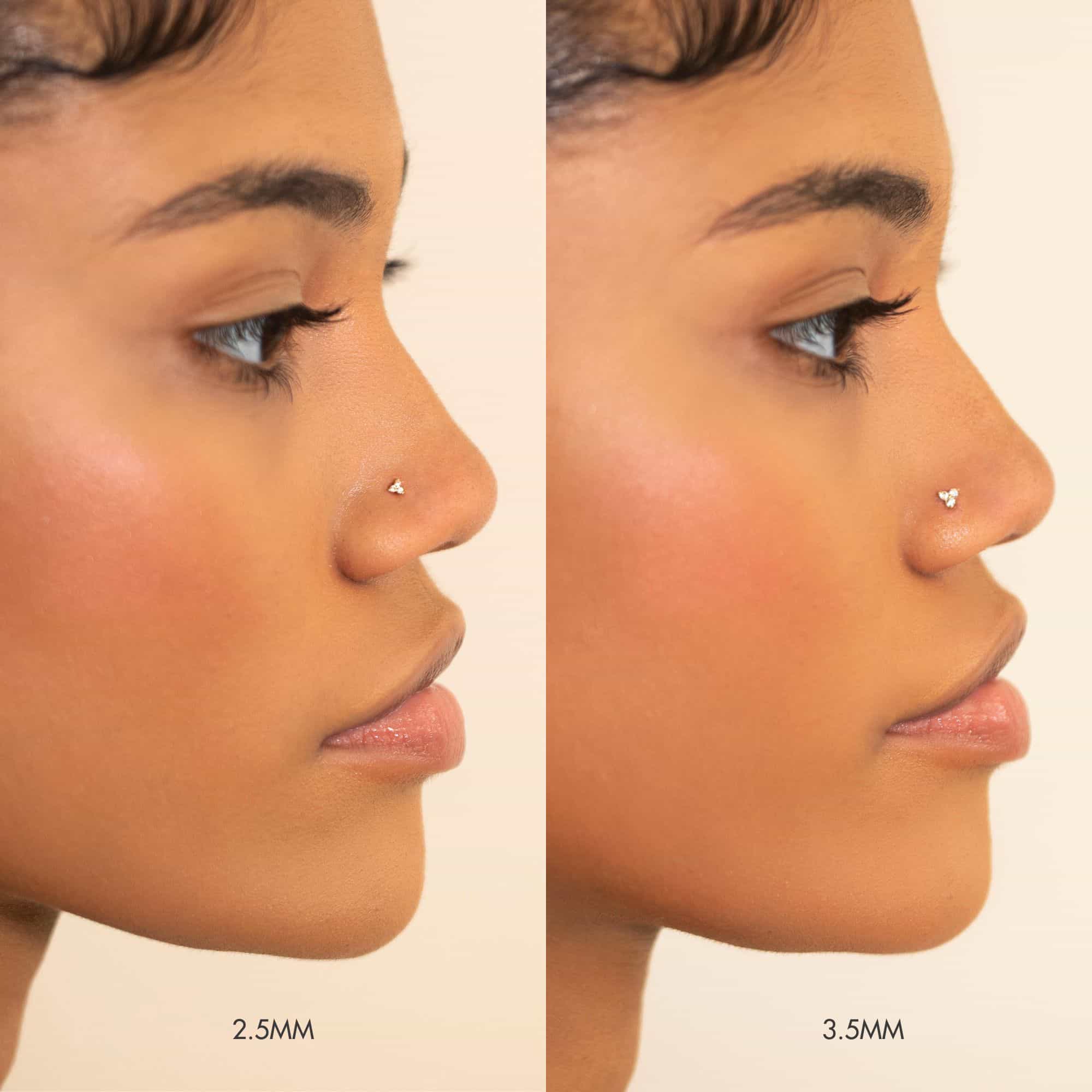 14K gold clover nose stud size comparison, 2.5mm and 3.5mm, shown on a model's nose