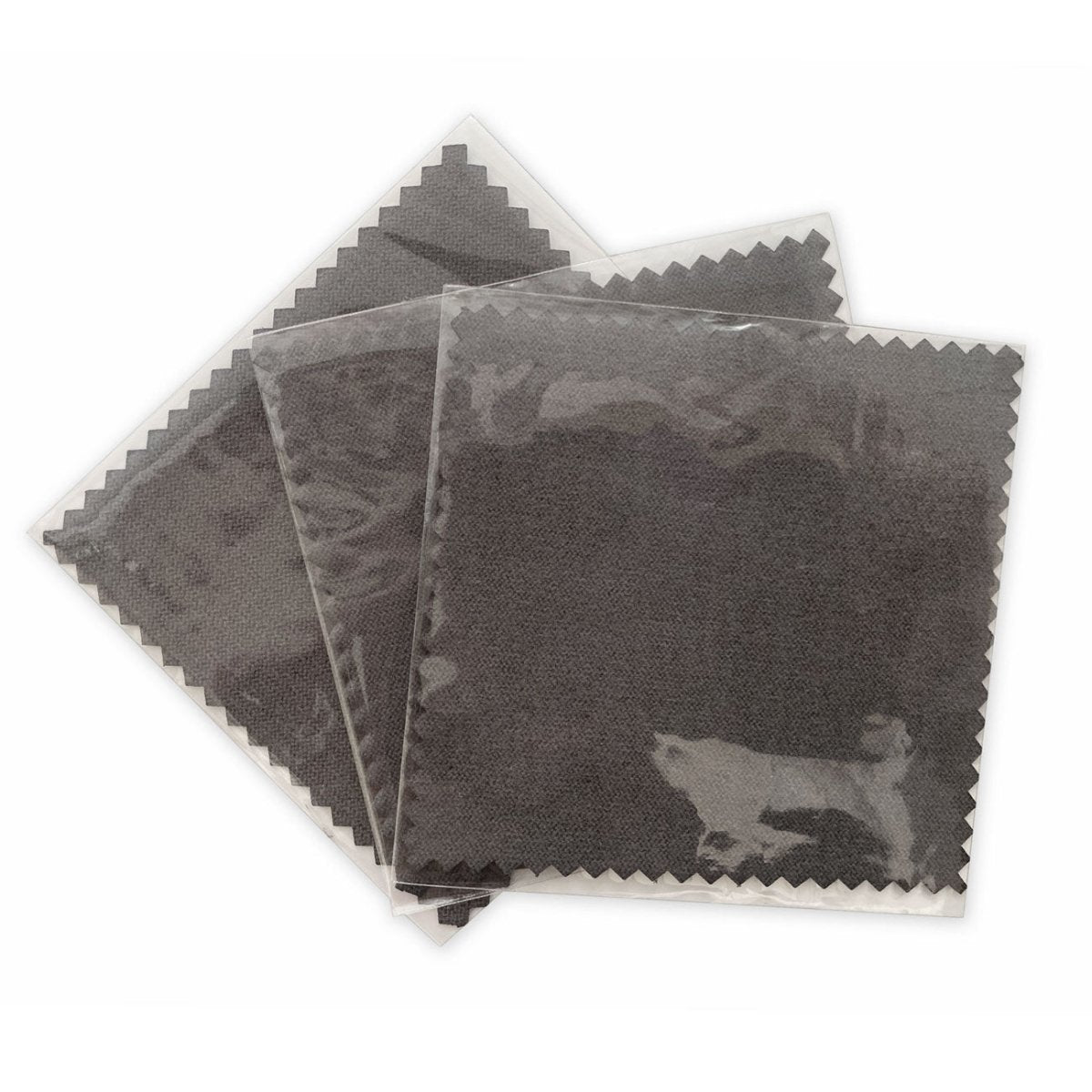 Set of three dark grey polishing cloths in clear plastic sleeves, on a white background