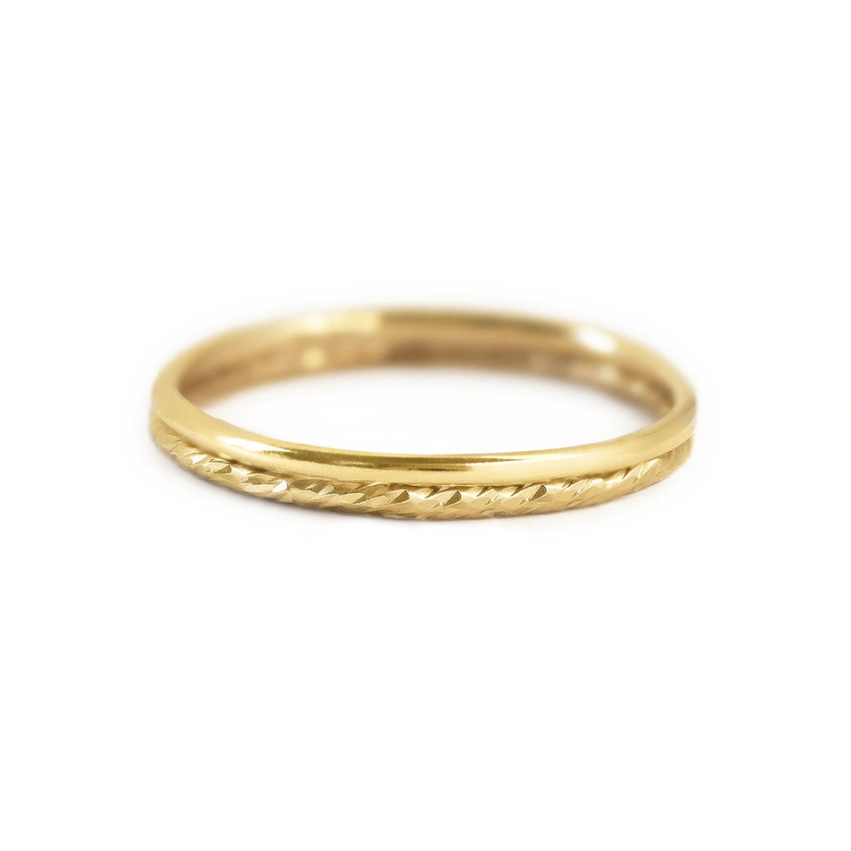 Gold-filled stacking ring set, a plain band and a diamond-cut textured band, on a white background
