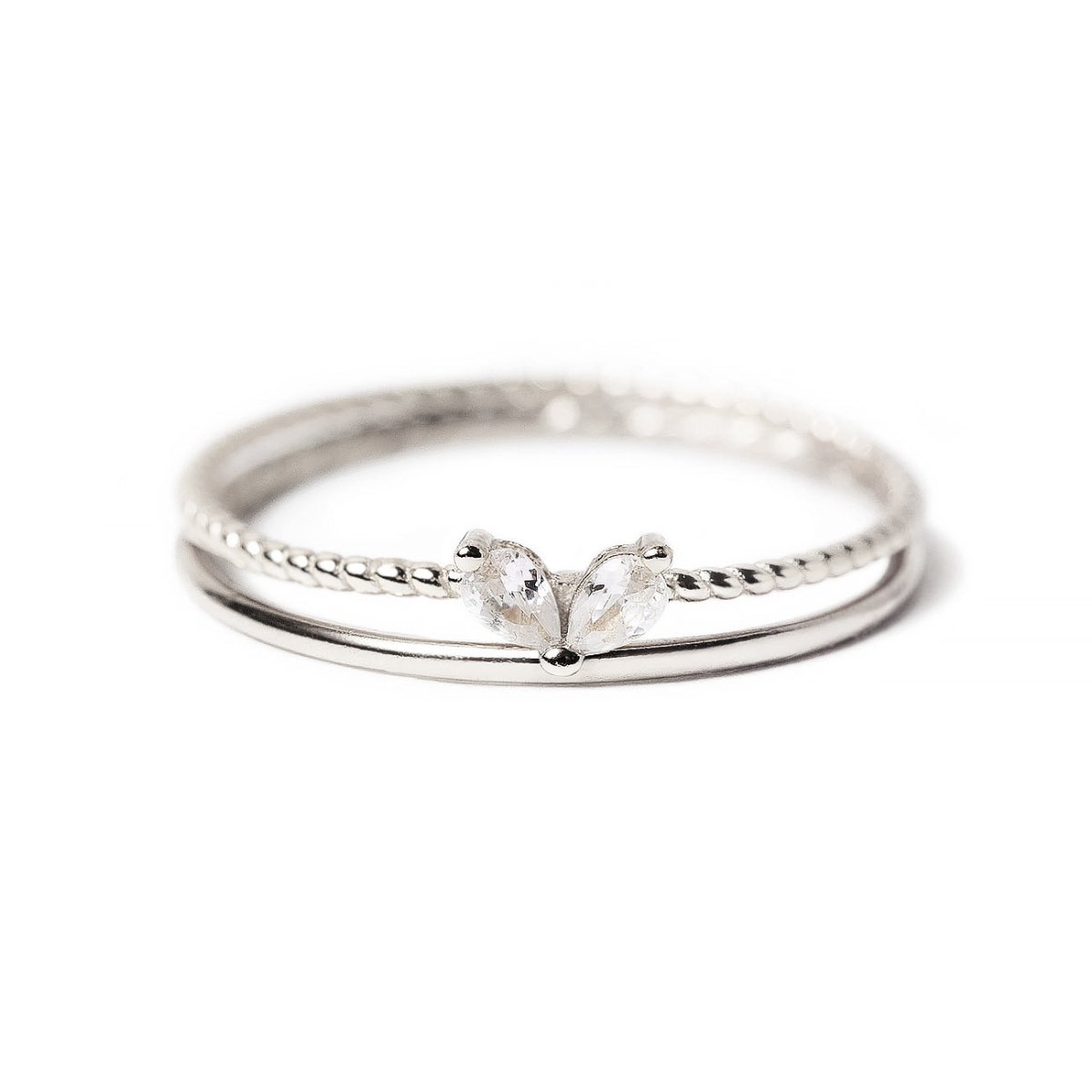 Sterling silver stacking ring set with twin pear-cut white zirconia stones, on a white background