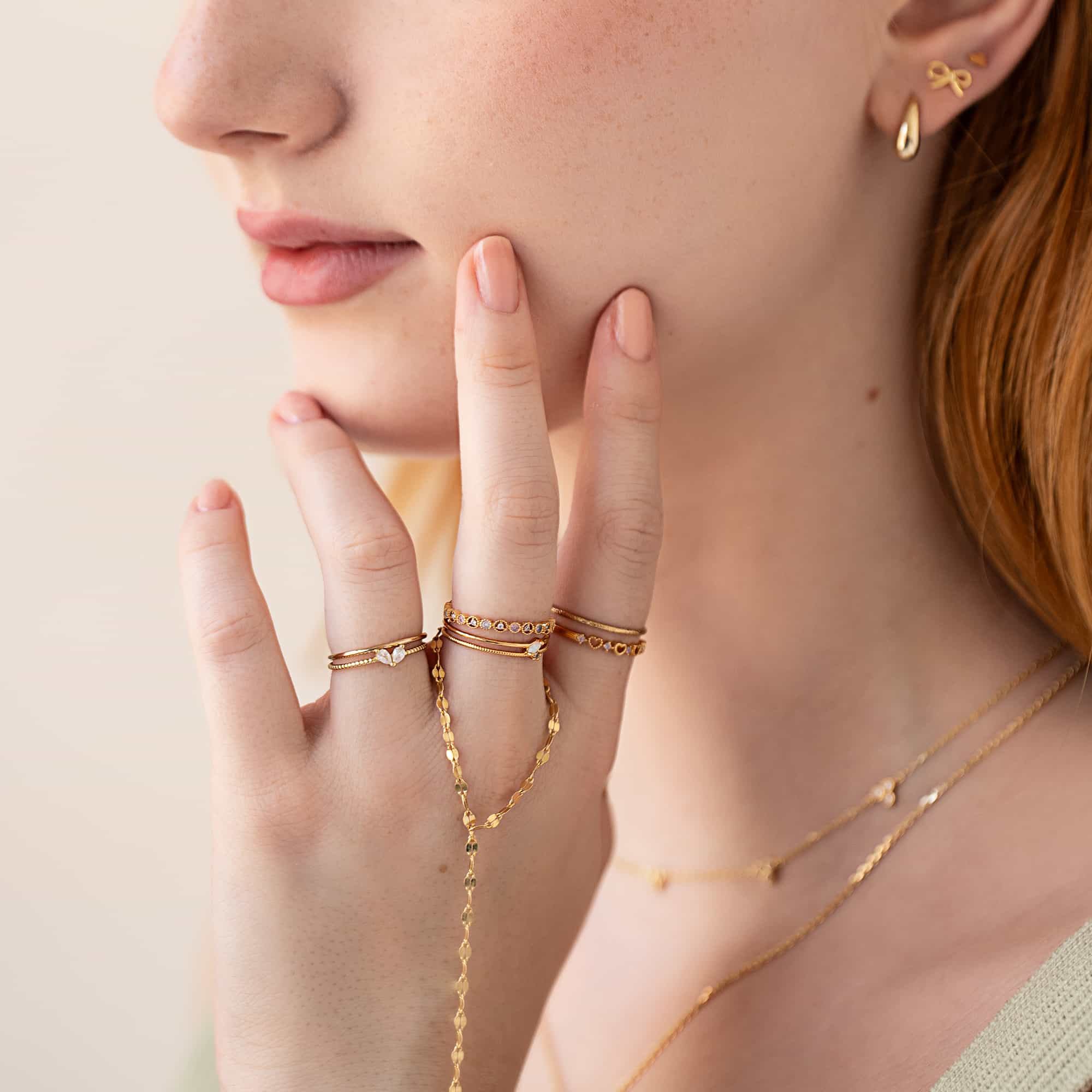 Gold vermeil eternity stacking ring shown stacked on a model's fingers