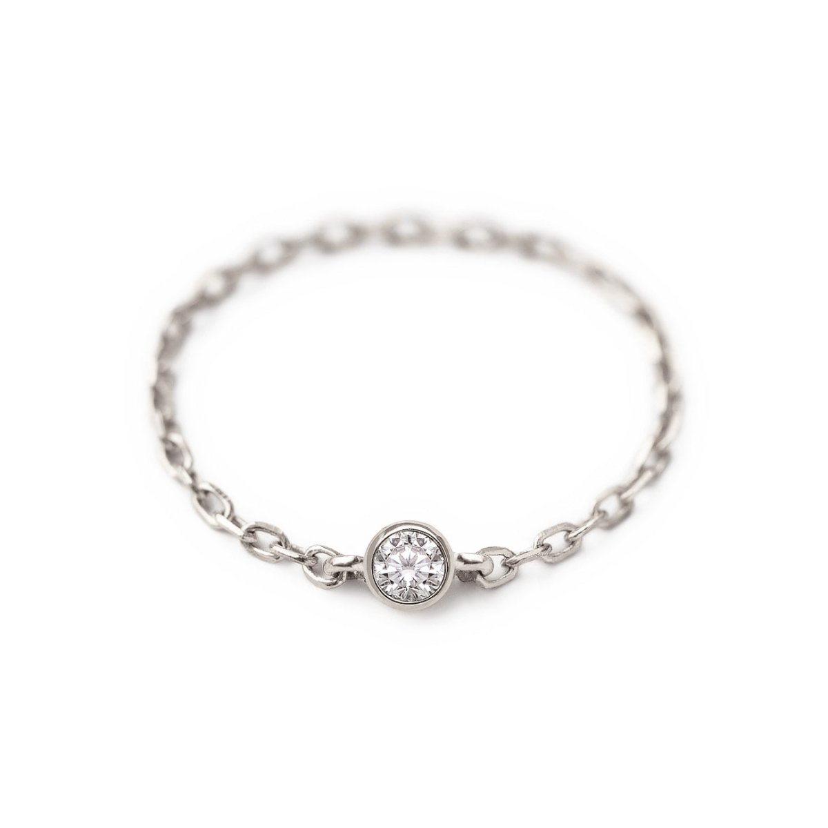 Sterling silver chain ring with a single bezel-set clear stone, on a white background