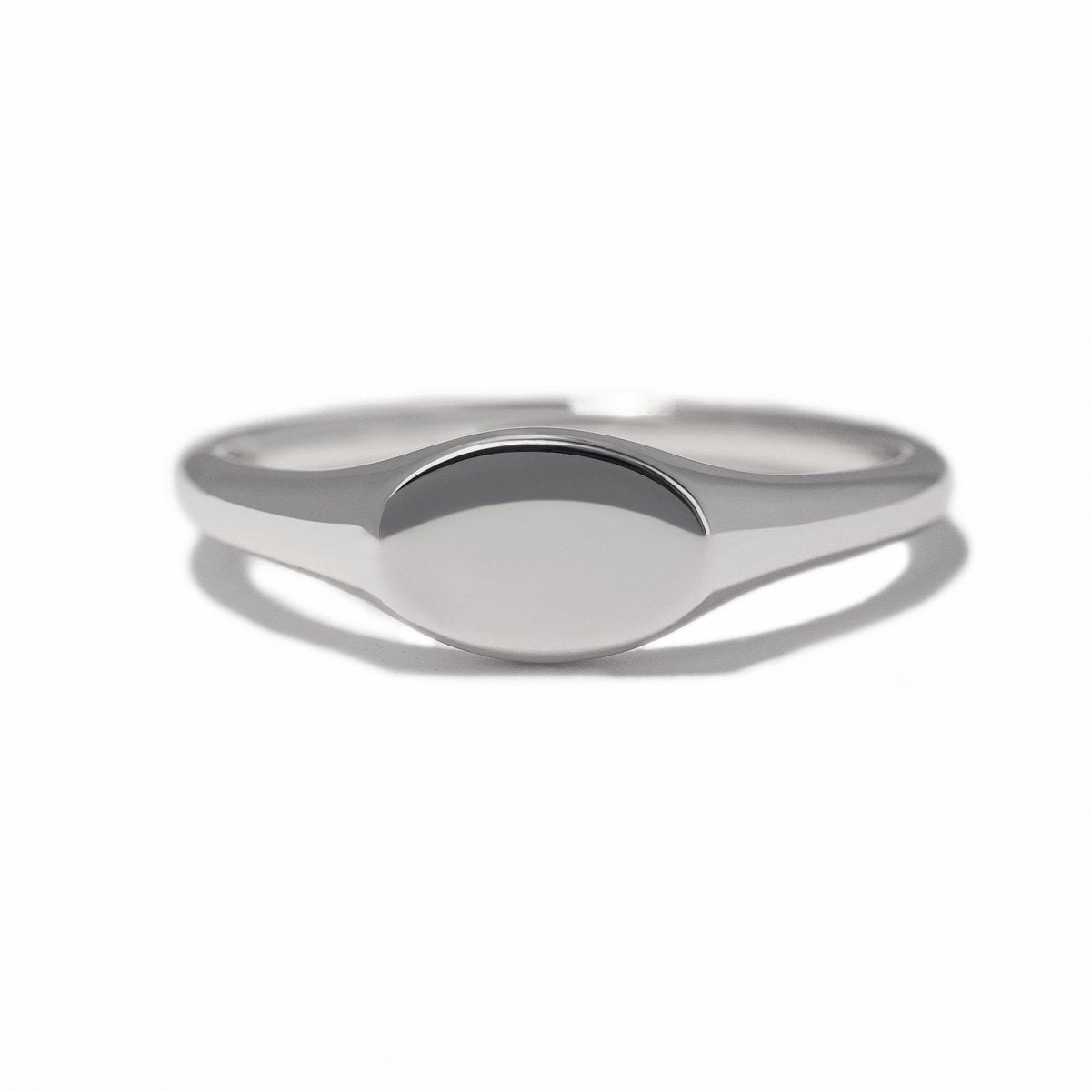 Sterling silver oval signet ring with a plain polished face, on a white background