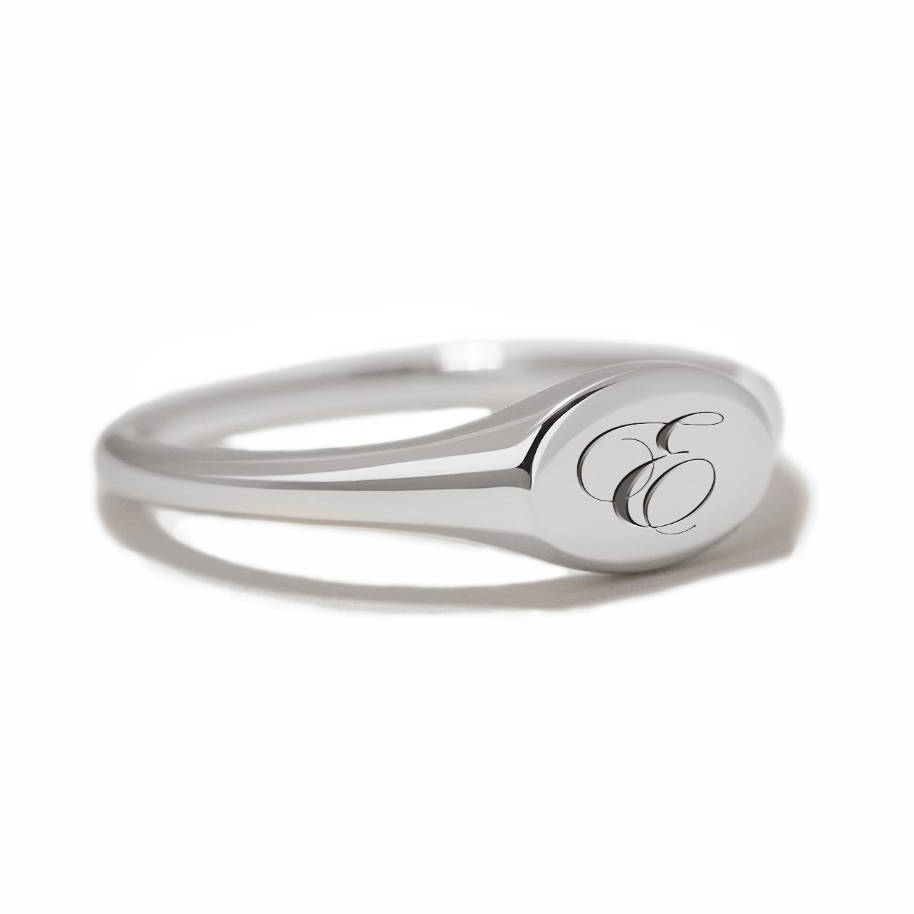 Sterling silver oval signet ring engraved with an initial, on a white background
