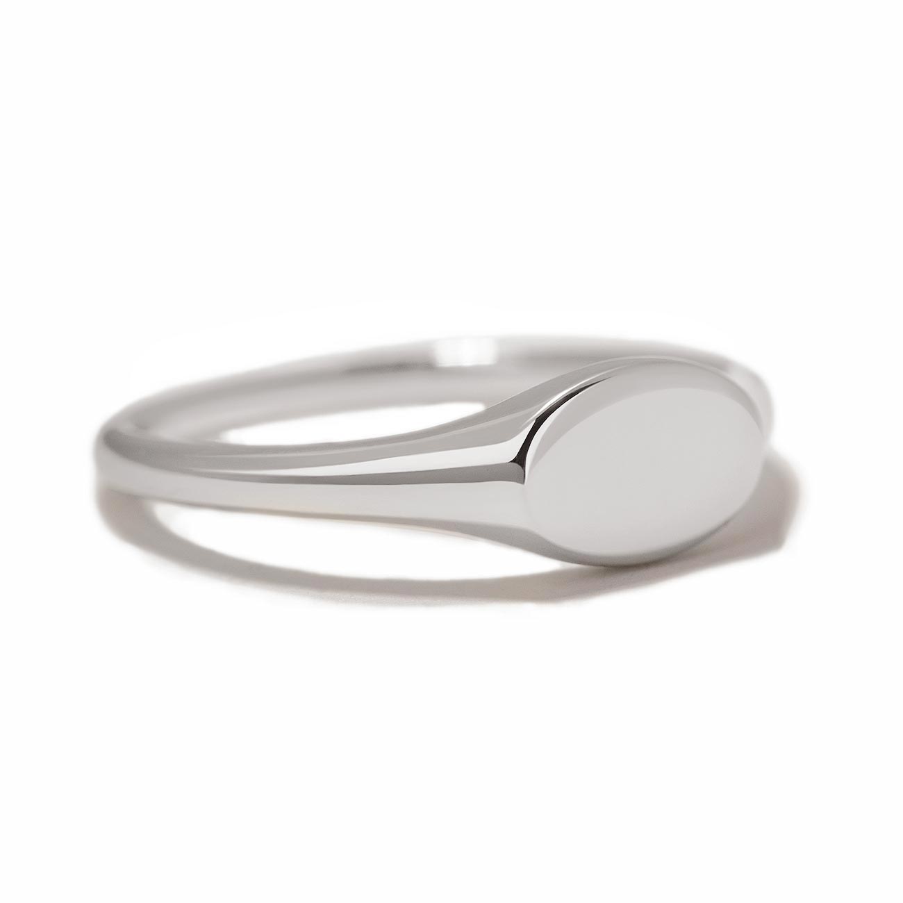 Sterling silver oval signet ring with a plain polished face, on a white background
