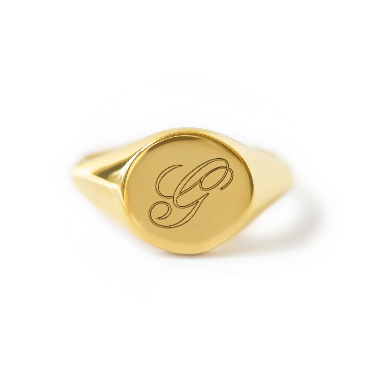 Gold vermeil signet ring engraved with a script initial, on a white background