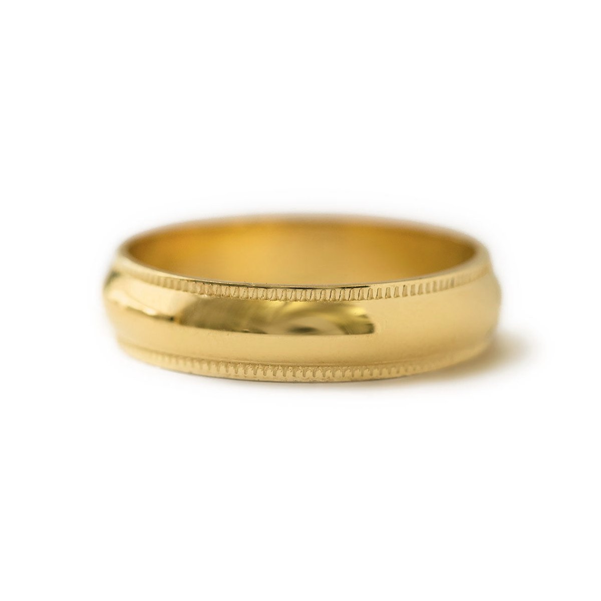 Gold vermeil domed band ring with milgrain beaded edges, on a white background