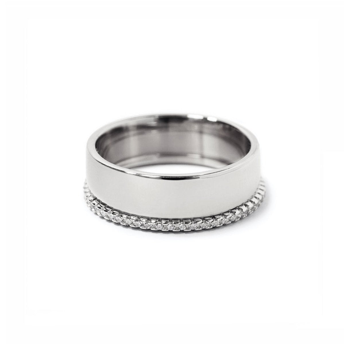 Sterling silver ring set, a wide band paired with a pavé white zirconia band, on a white background