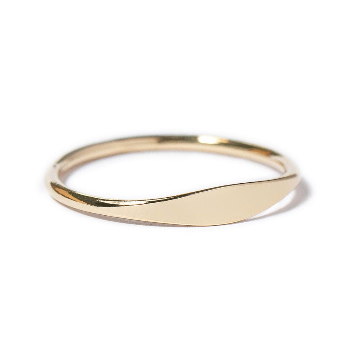 Gold-filled thin signet ring, side angle showing the slim band and flat oval face, on a white background