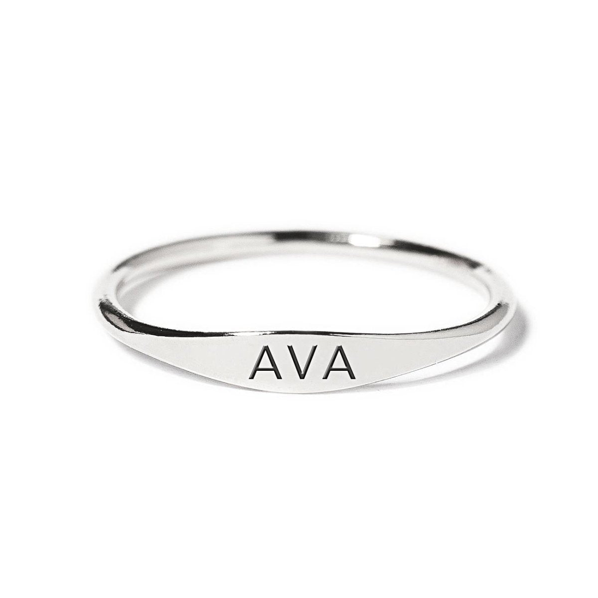 Sterling silver thin signet ring engraved with a name, shown on a white background