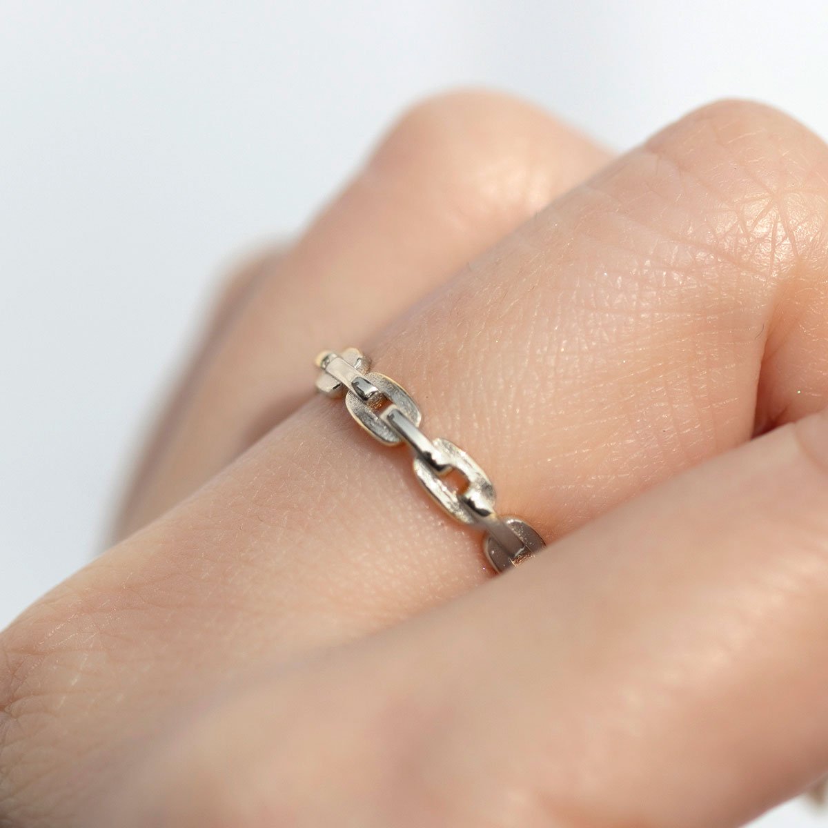 Sterling silver chain link band ring, shown on a model's finger
