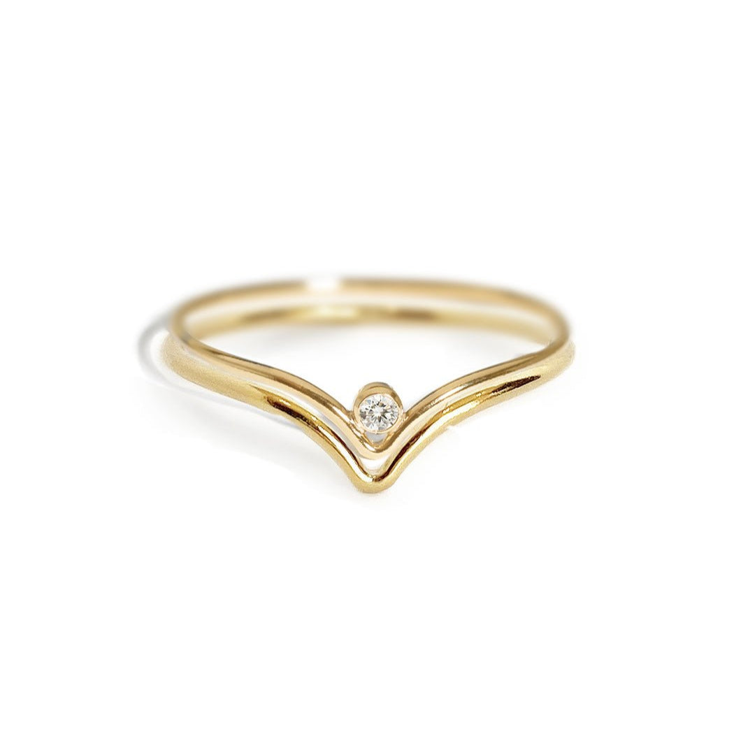 Gold-filled chevron ring with a single clear stone, close-up detail on a white background