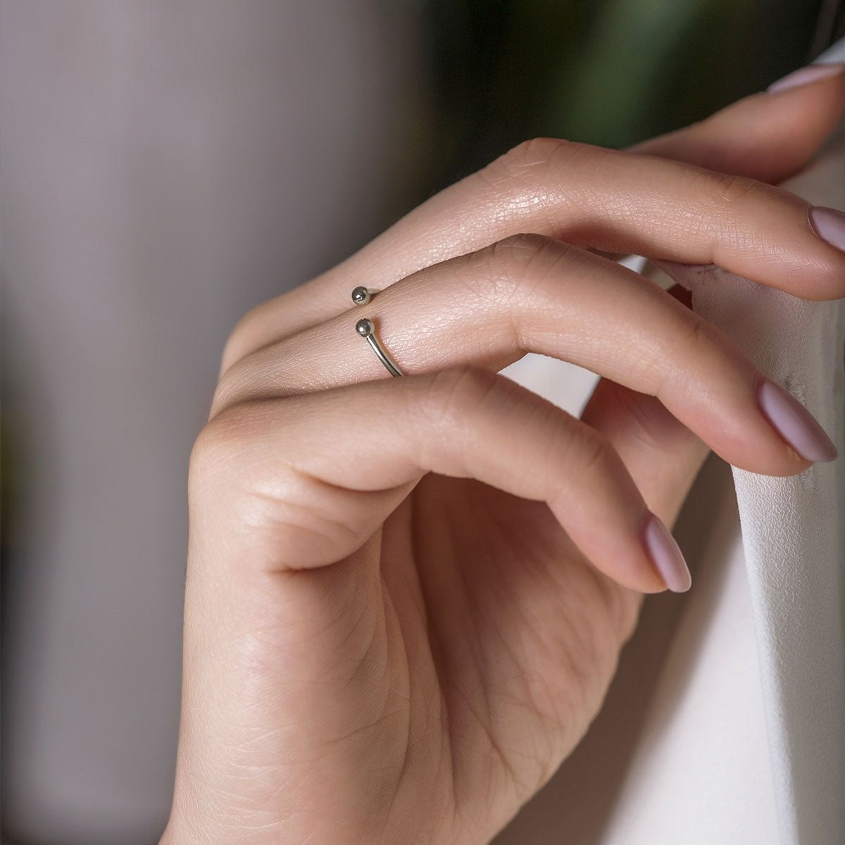Sterling silver open ball-end ring, shown on a model's finger