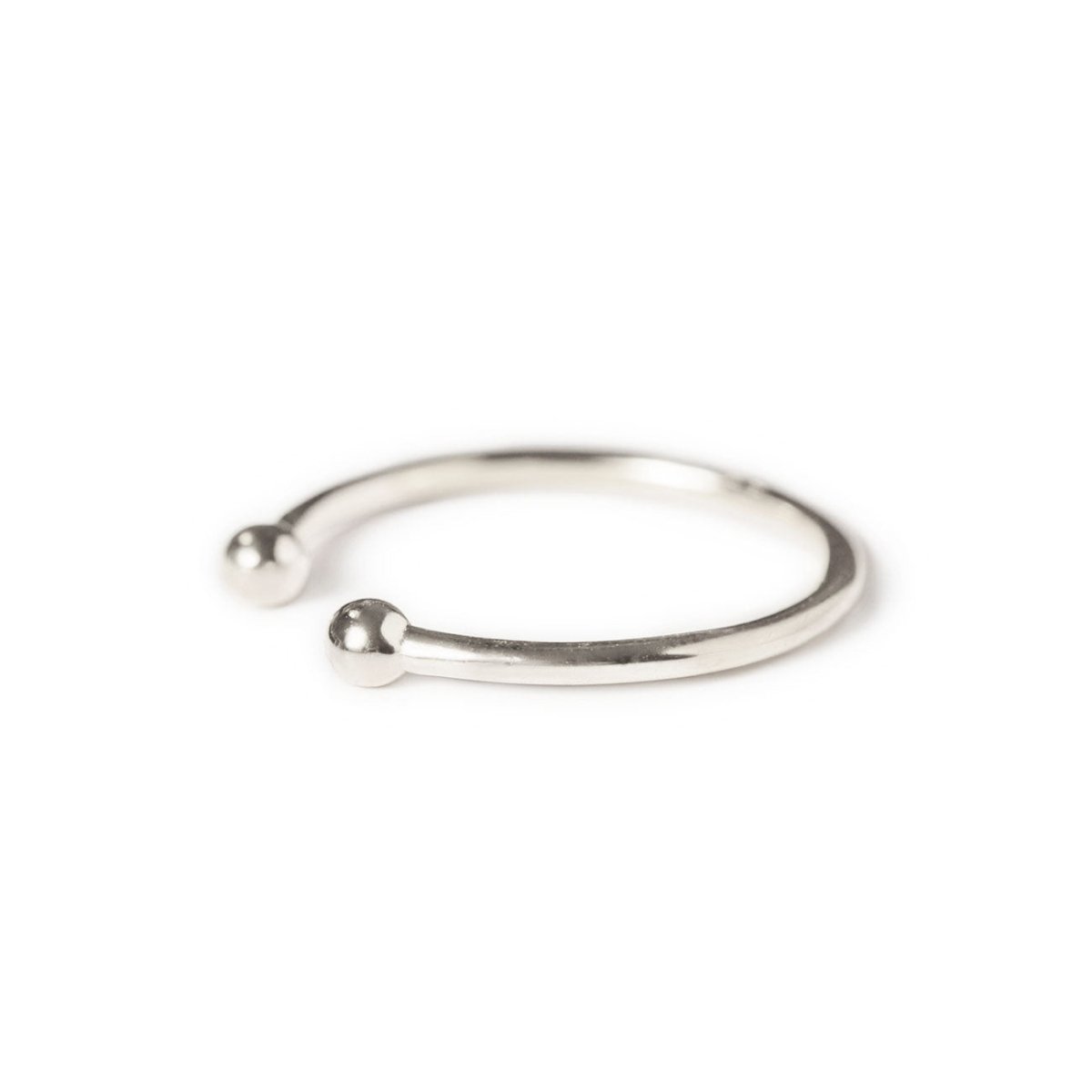 Sterling silver open ring with ball ends, angled side view on a white background