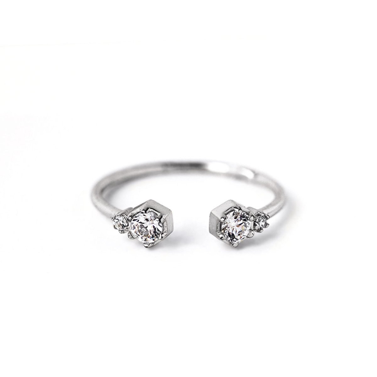 Sterling silver open cuff ring with two clear zirconia stones in hexagon settings, on a white background