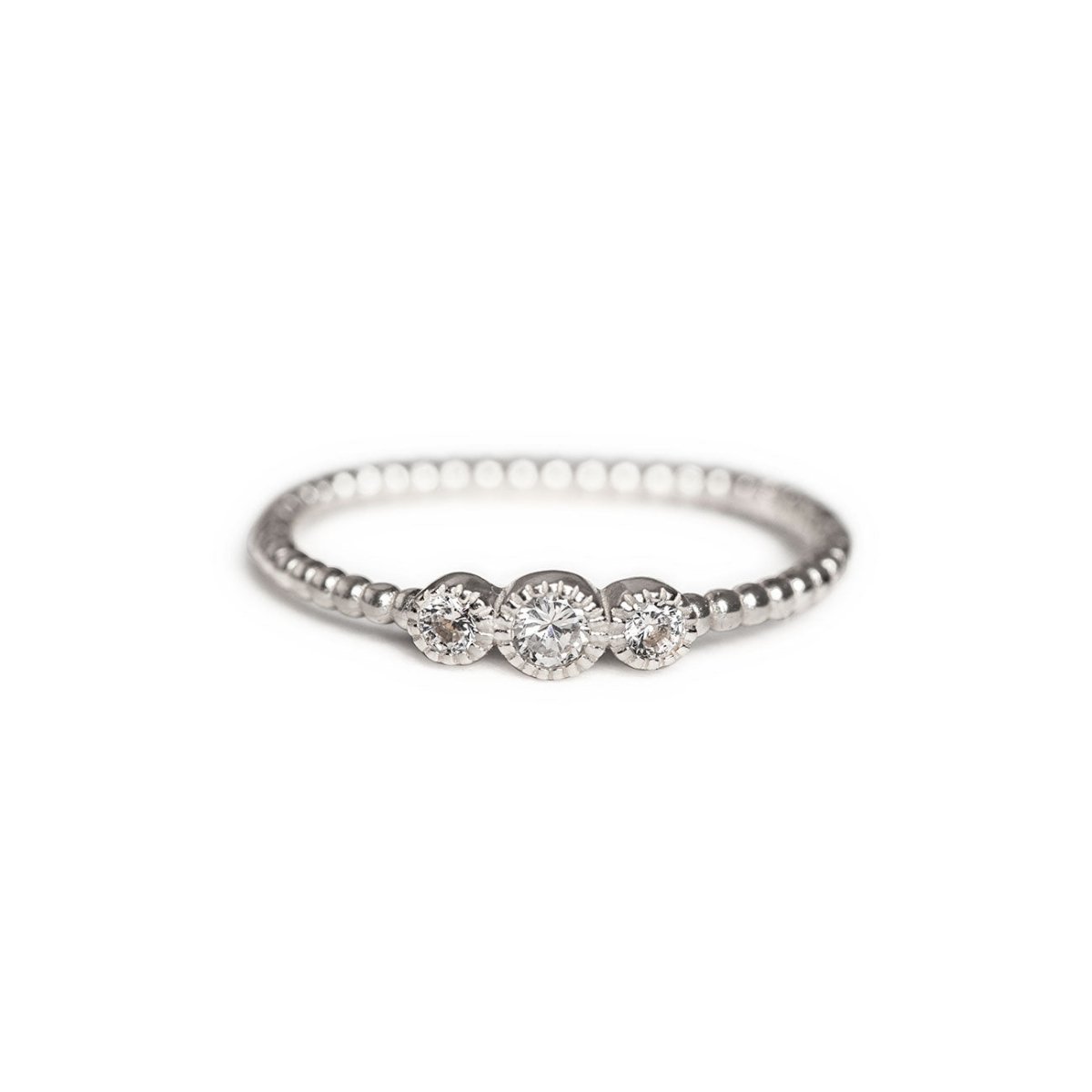 Sterling silver beaded ring with three round white zirconia stones, on a white background