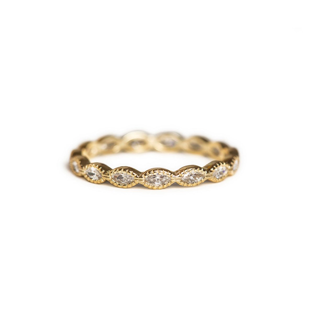 Gold vermeil marquise white zirconia eternity band ring with milgrain detail, on a white background