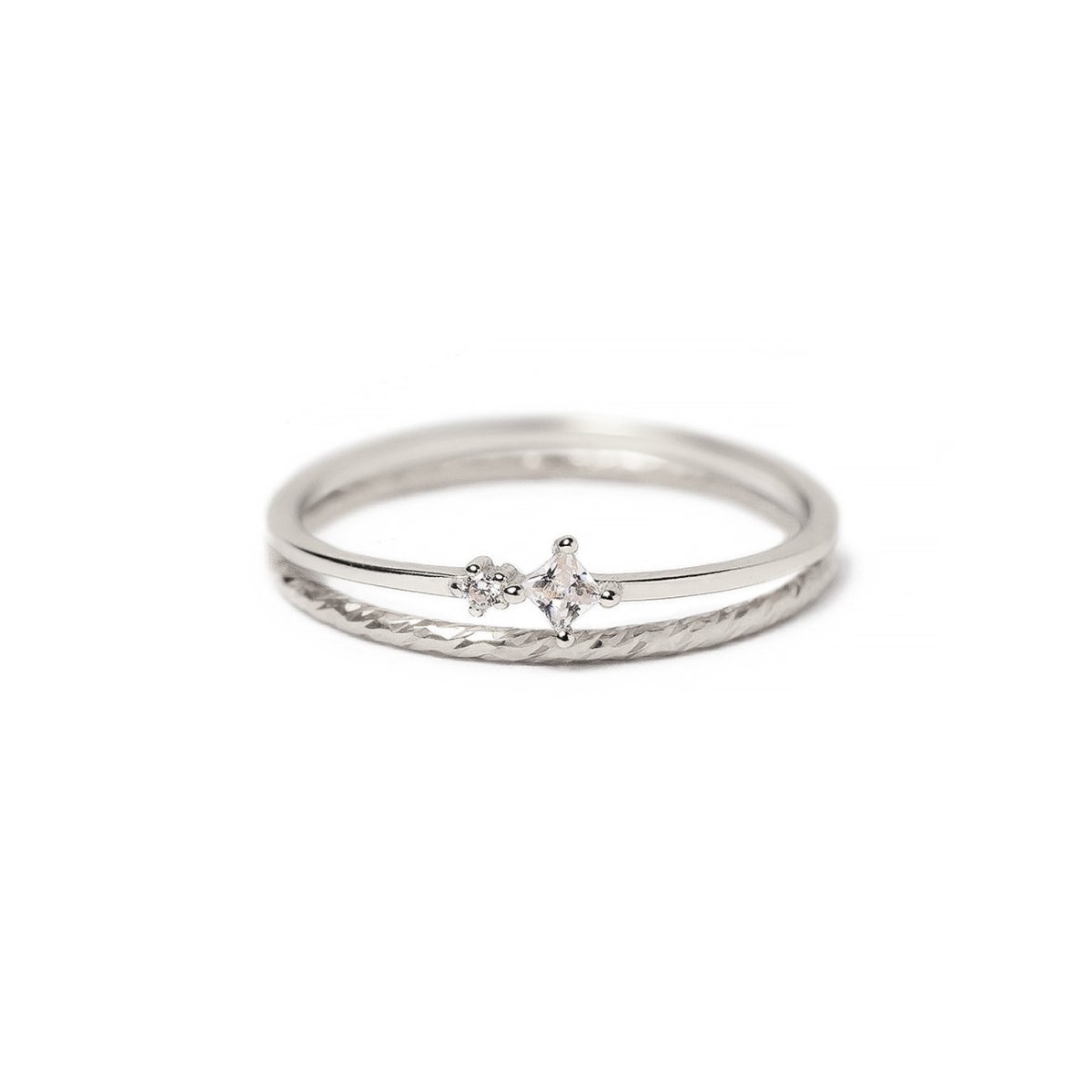 Sterling silver thin double-band ring with white zirconia stones and a textured band, on a white background