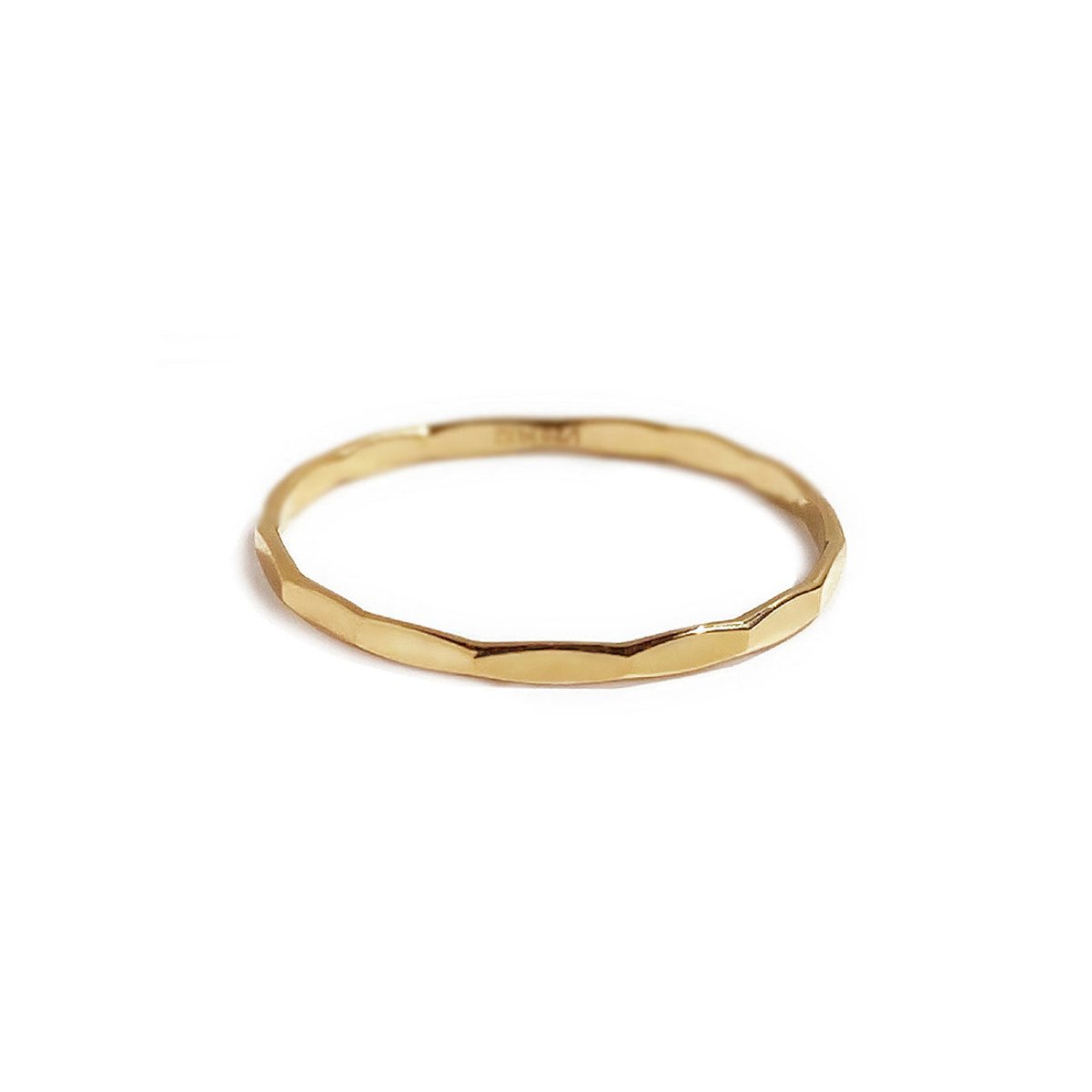Gold-filled hammered thin stacking ring with a faceted band, on a white background