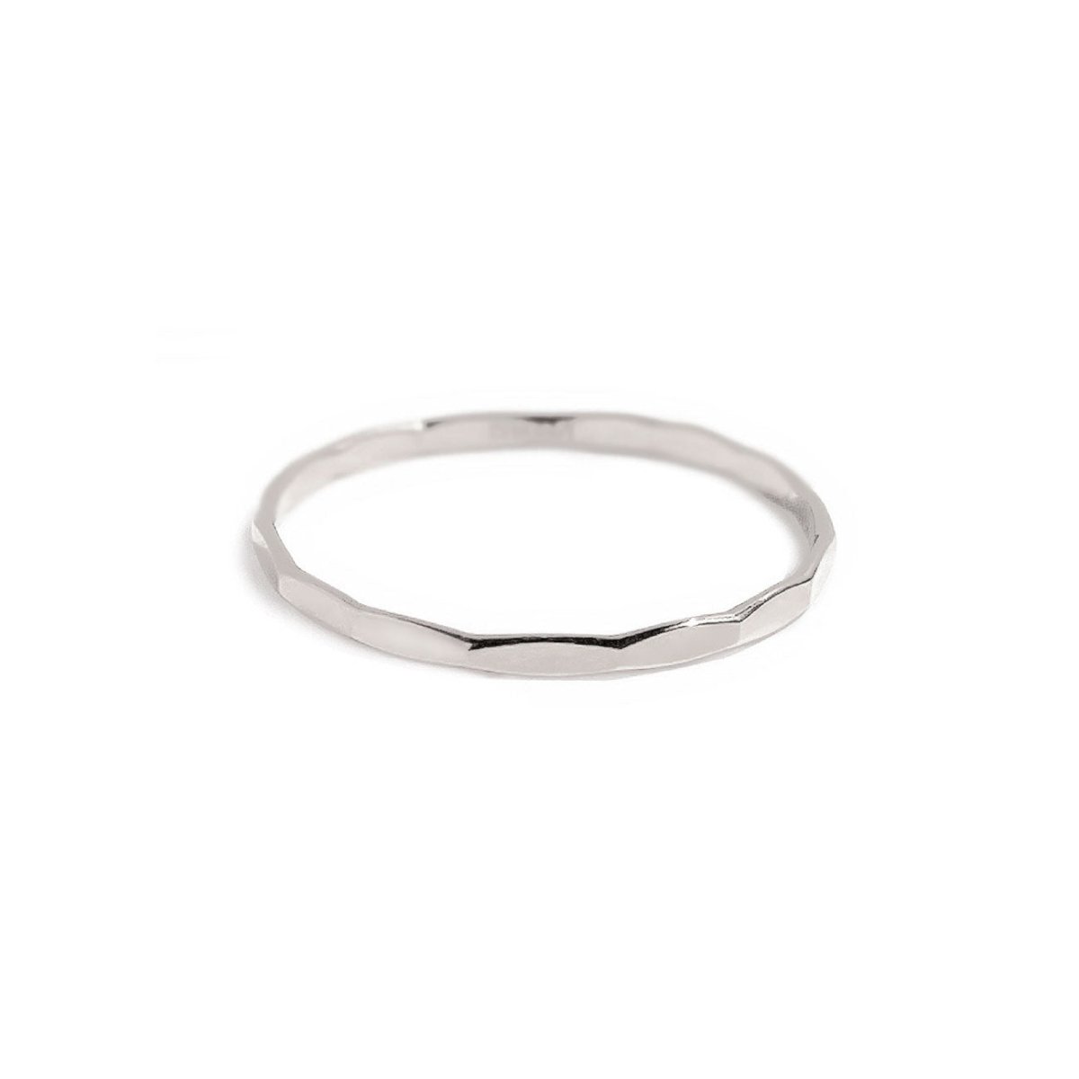Sterling silver hammered thin stacking ring with a faceted band, on a white background