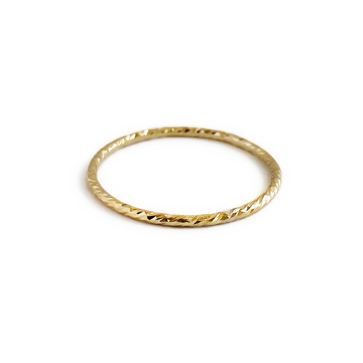 14K gold thin band ring with a sparkly diamond-cut texture, on a white background