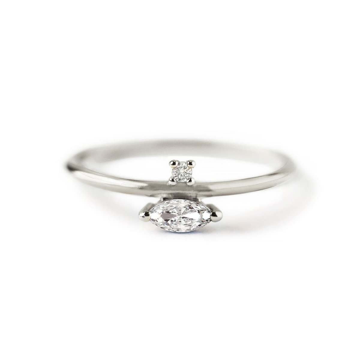 Sterling silver marquise band ring with a horizontal clear stone and a small round accent, on a white background