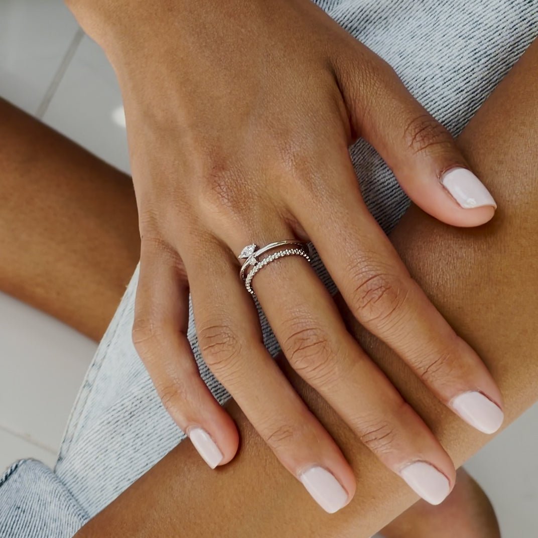 Sterling silver marquise band ring with white zirconia, stacked and shown on a model's finger