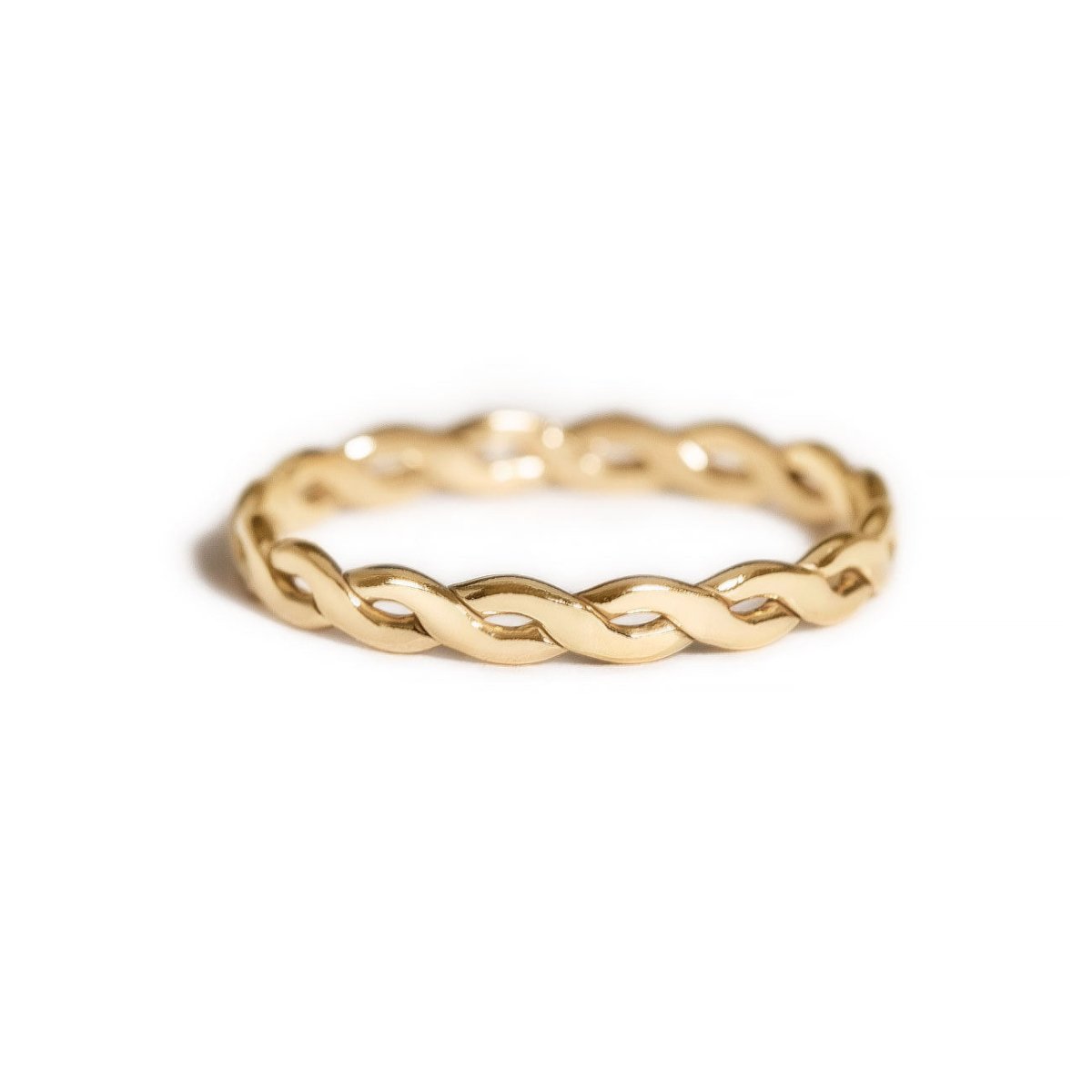 Gold-filled woven ring with a braided band, on a white background