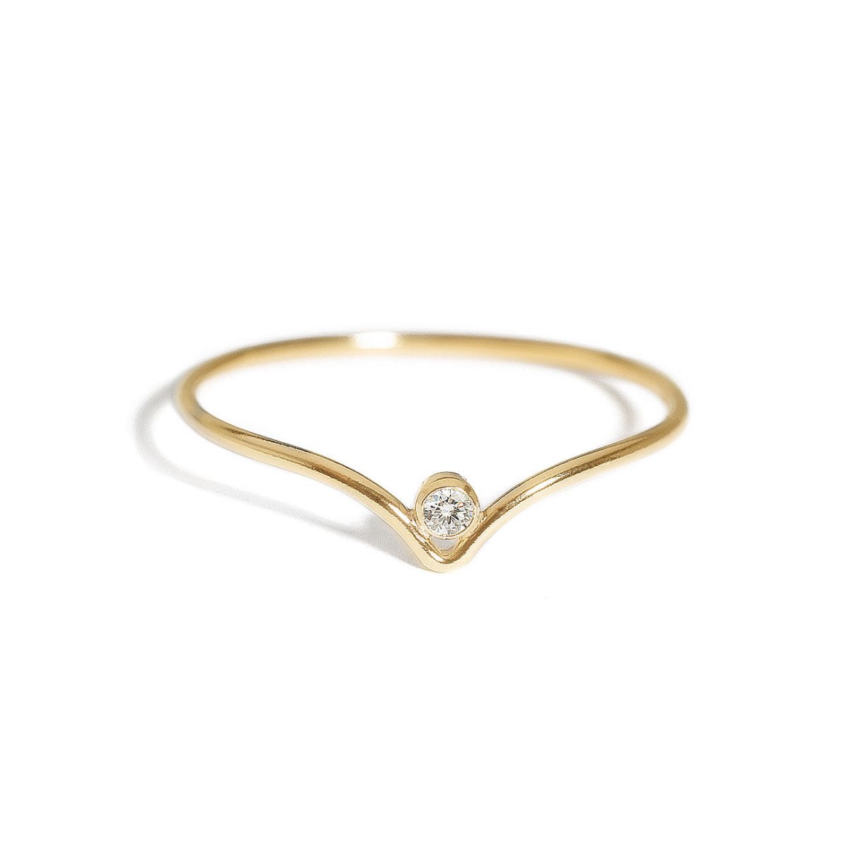 Gold-filled thin chevron ring with a single white zirconia stone, on a white background
