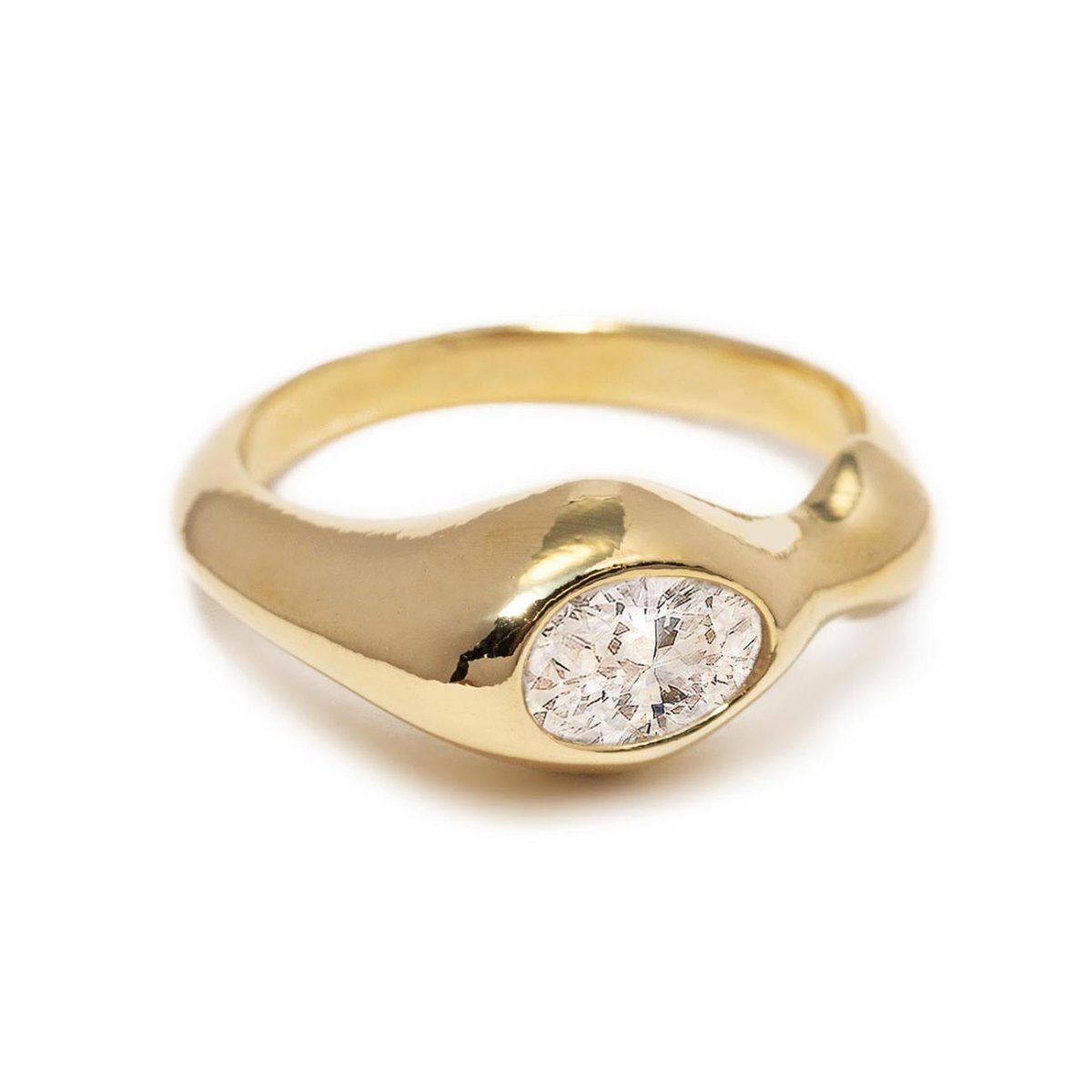Gold vermeil sculptural ring with an oval white zirconia, on a white background