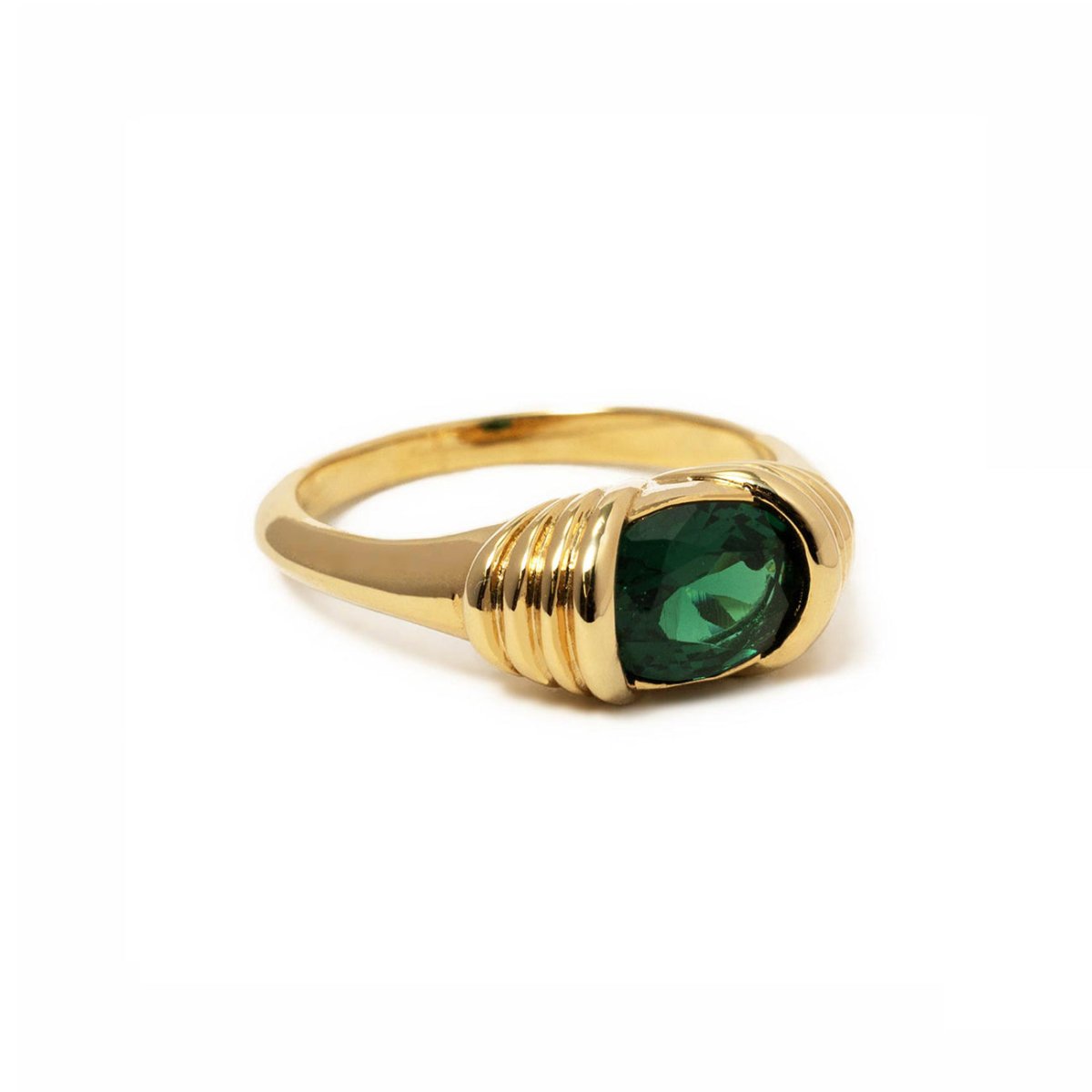 Gold vermeil statement ring with a horizontal oval green emerald and ribbed shoulders, on a white background