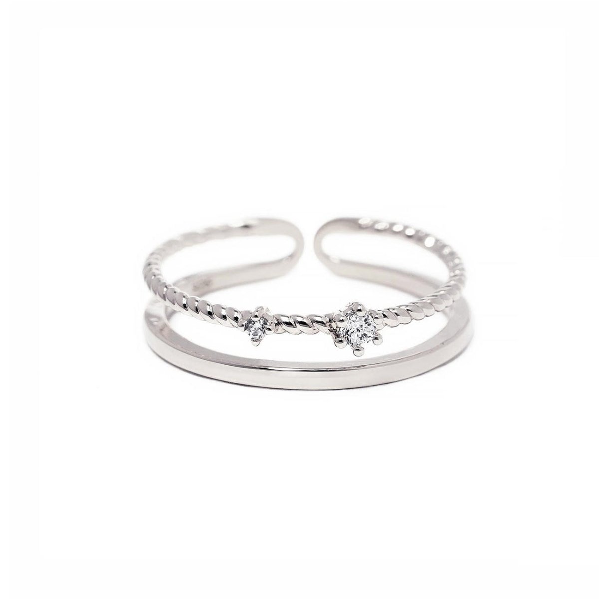 Sterling silver rope stacking ring with prong-set white zirconia stones and an open adjustable band, on a white background