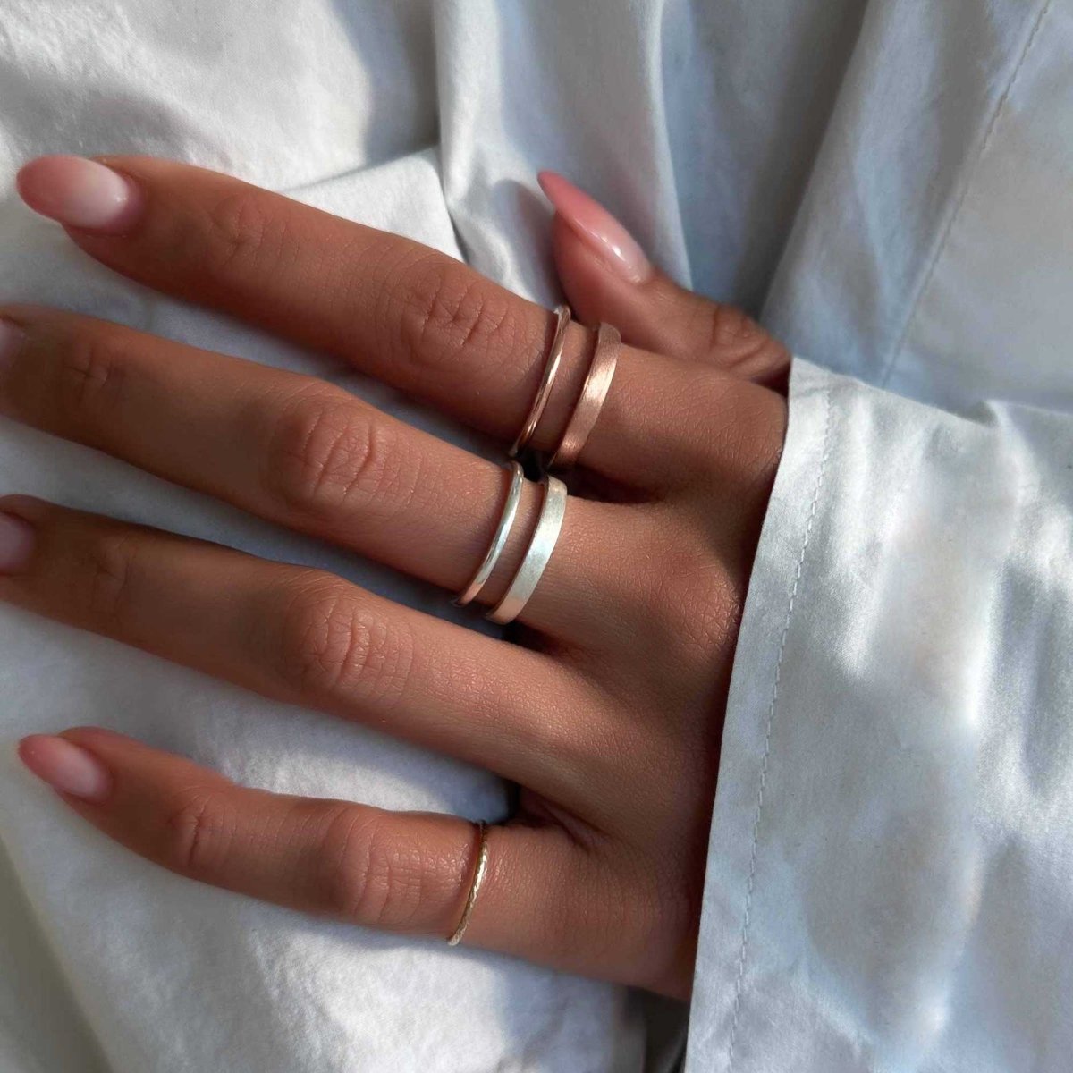 Rose gold vermeil double band ring with a matte lower band, shown on a model's finger