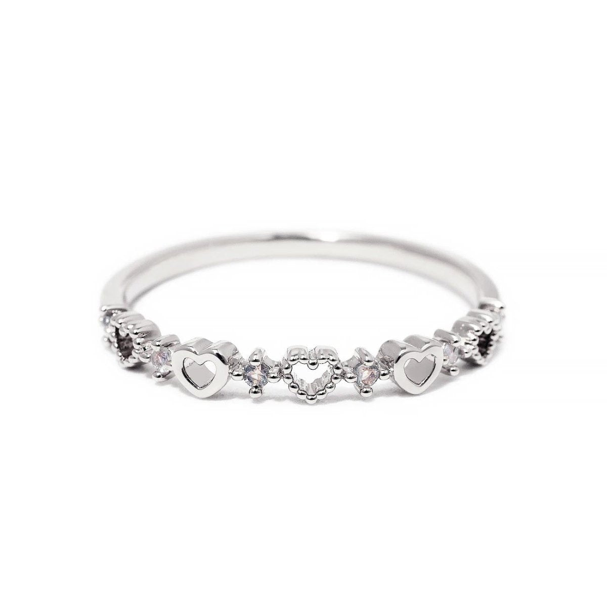 Sterling silver heart band ring with open and solid hearts and clear stones, on white background