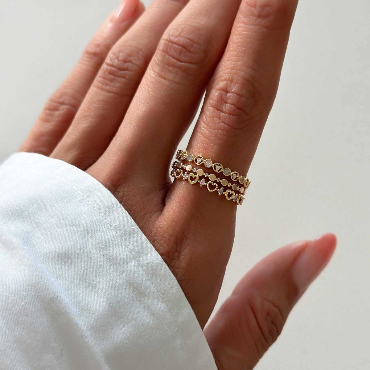 Gold vermeil eternity stacking rings shown stacked on a model's hand