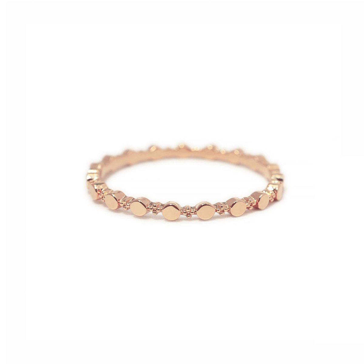 Rose gold vermeil flat beaded stacking ring, close-up on a white background