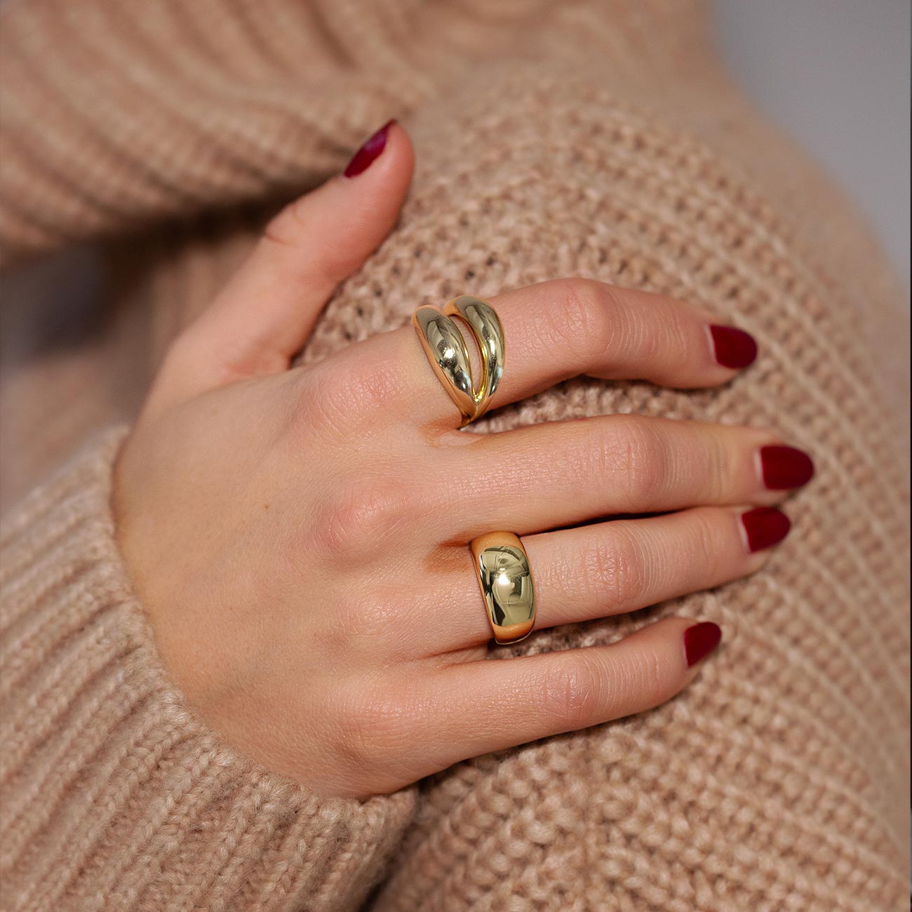 Gold double-band dome ring and a single dome ring shown on a model's fingers
