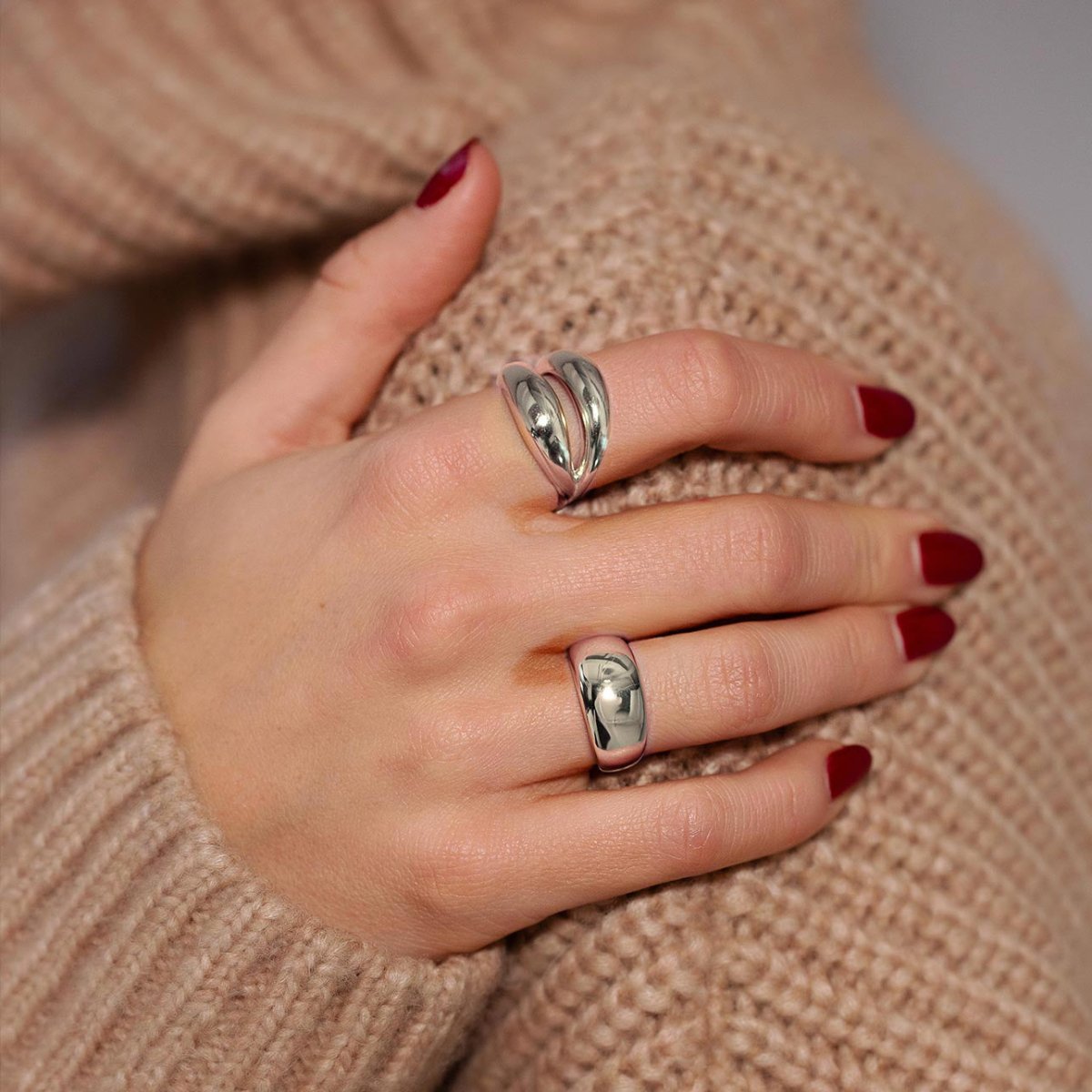 Sterling silver domed and double-band rings shown on a model's fingers