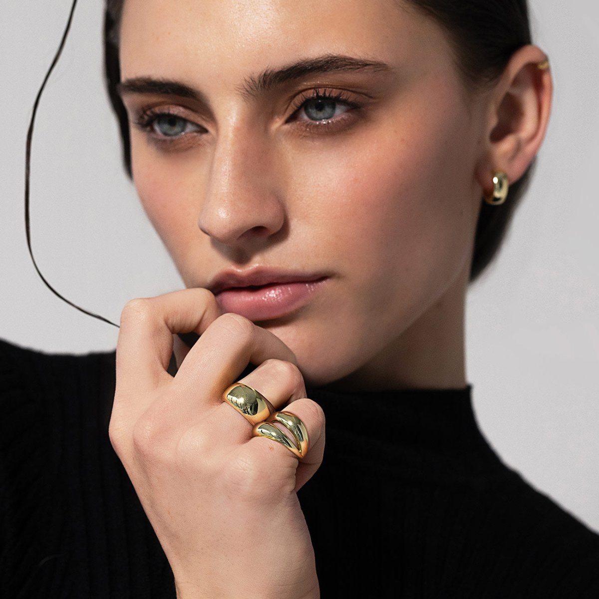 Gold vermeil domed and double-band rings shown stacked on a model's fingers