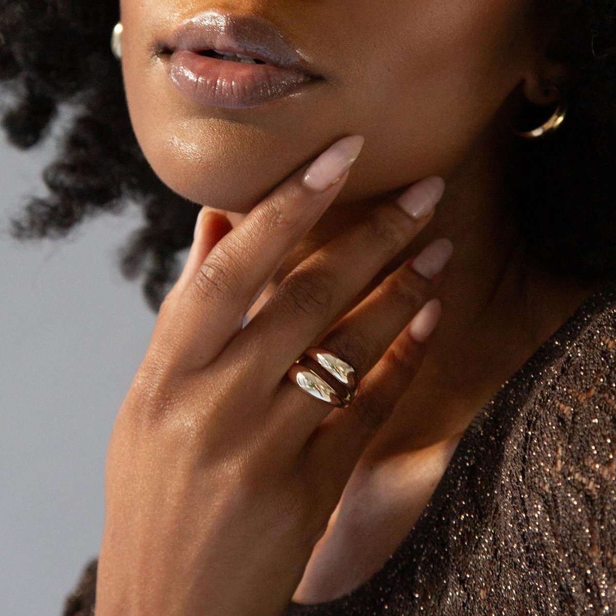 Gold vermeil double dome ring beside a single dome ring, shown at an angle on a cream background